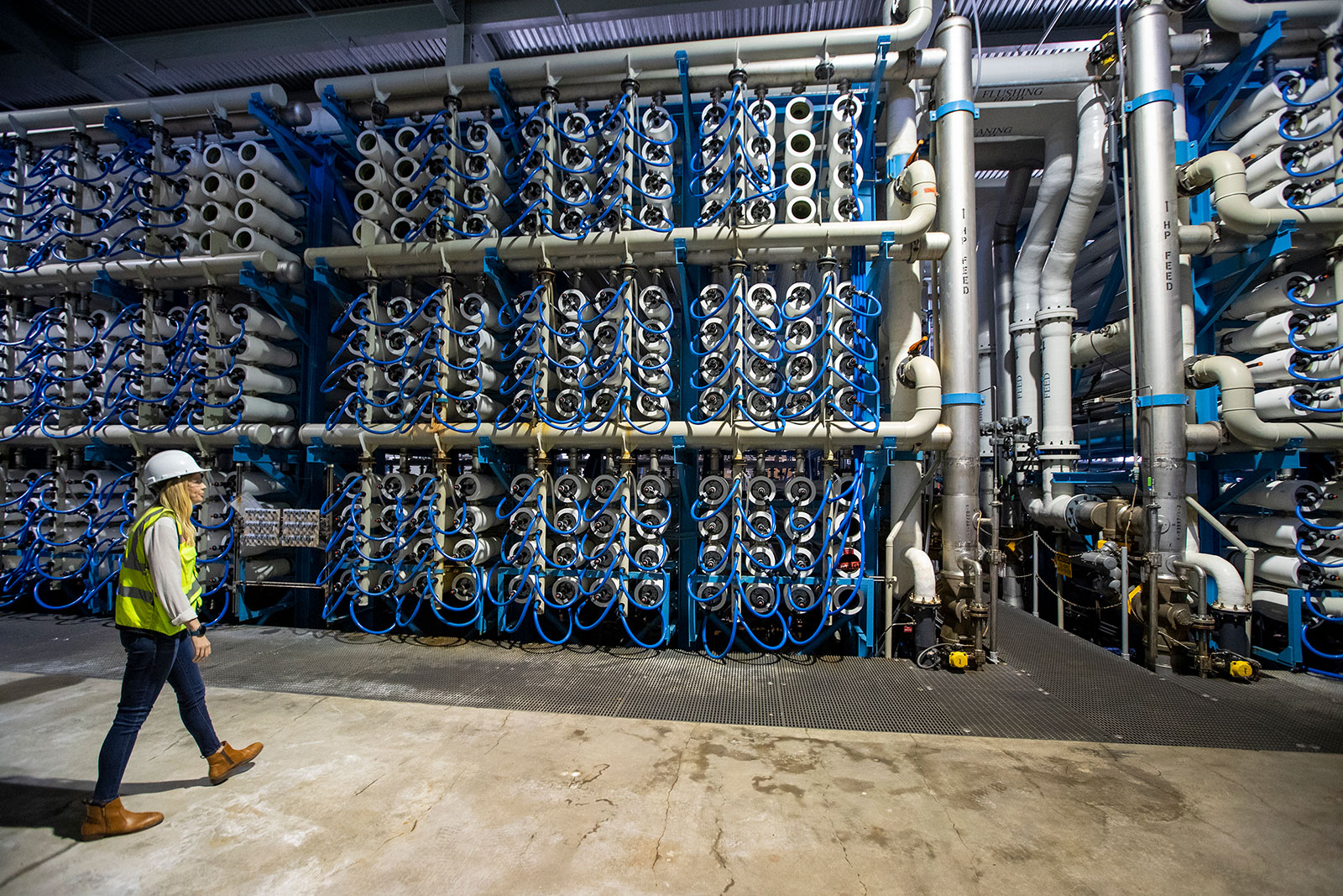 Michelle Peters, technical and compliance manager for Poseidon Water, walks through the reverse osmosis building at the Claude “Bud” Lewis Carlsbad Desalination Plant in Carlsbad, California, on March 30.
