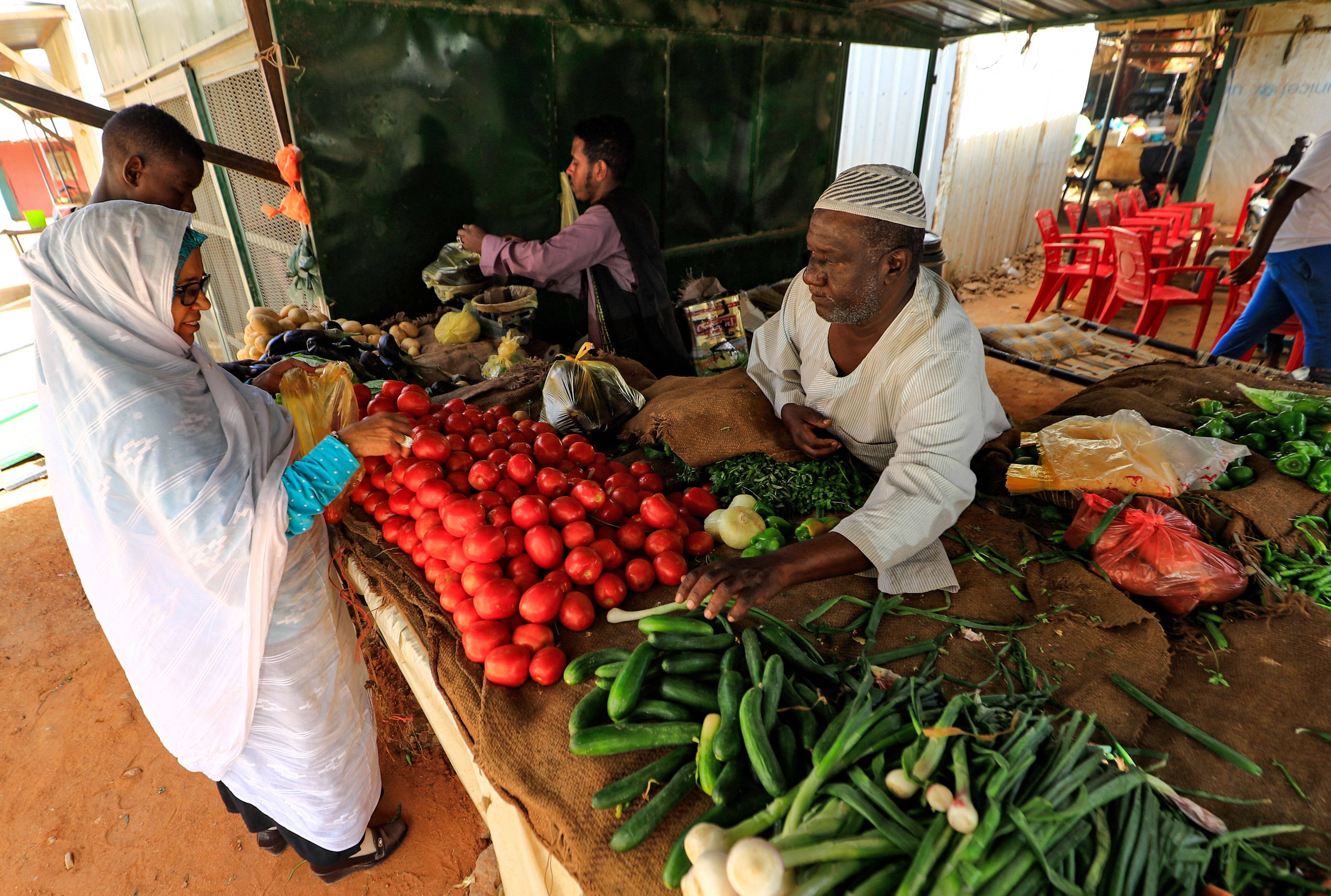A Sudanese woman buys vegetables at the Al-Khaimah market in Khartoum's Arkawit district on March 17 as food prices rise across Sudan and the region due to the conflict in Ukraine.