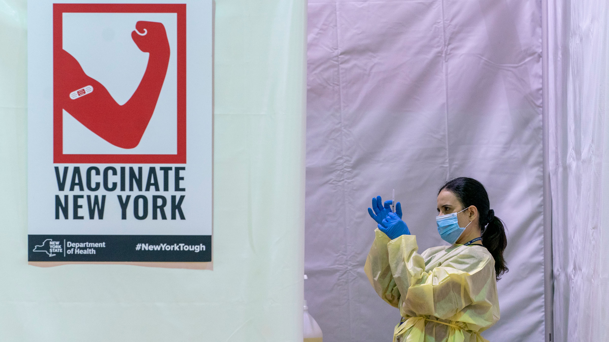 Registered nurse Rita Alba taps the air out of a syringe before vaccinating a patient at a pop-up site in New York on January 31.