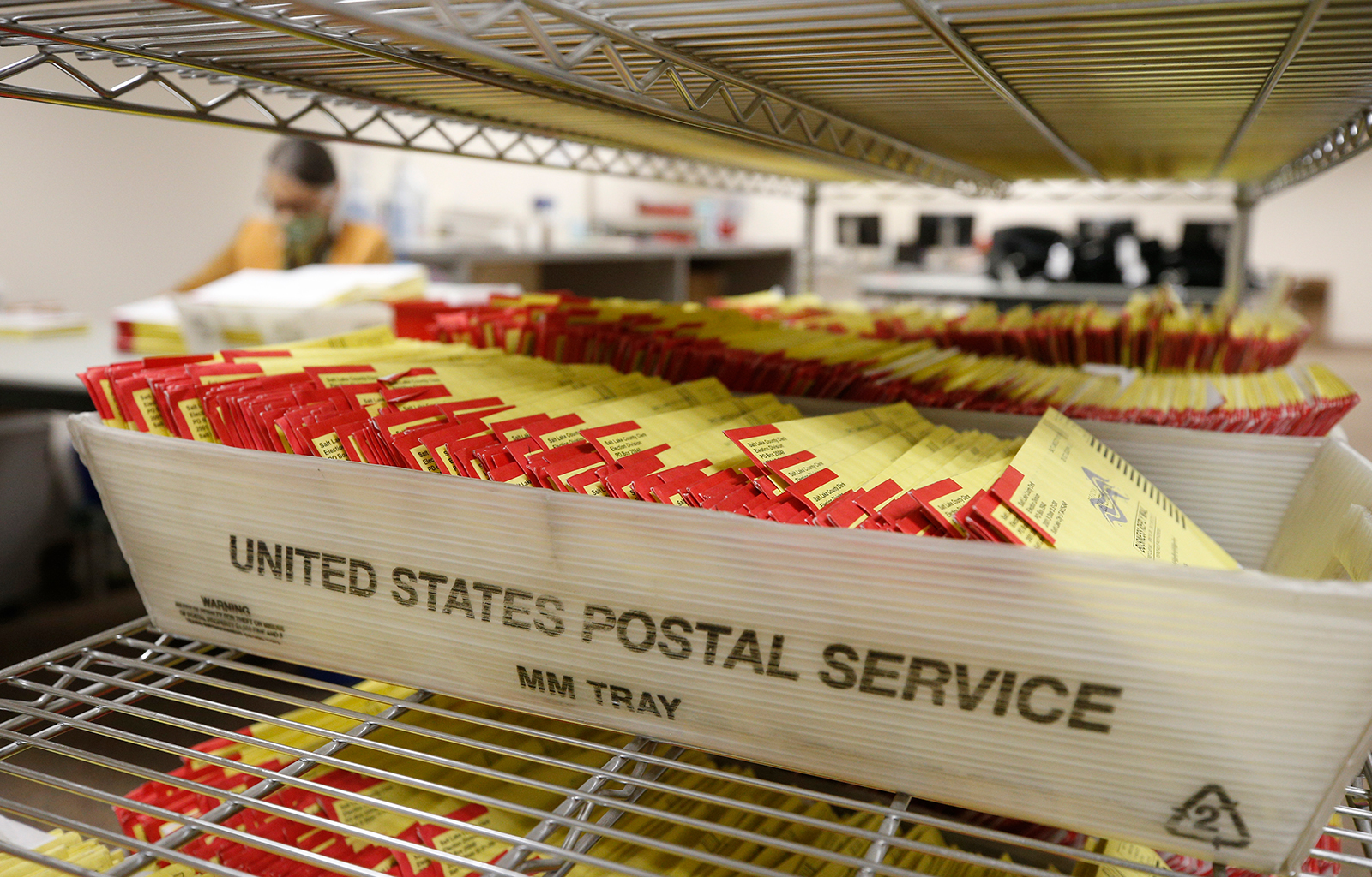 Mail-in ballots sit in containers from the US Postal Service waiting to be processed by election workers at the Salt Lake County election office in Salt Lake City, Utah on October 29.