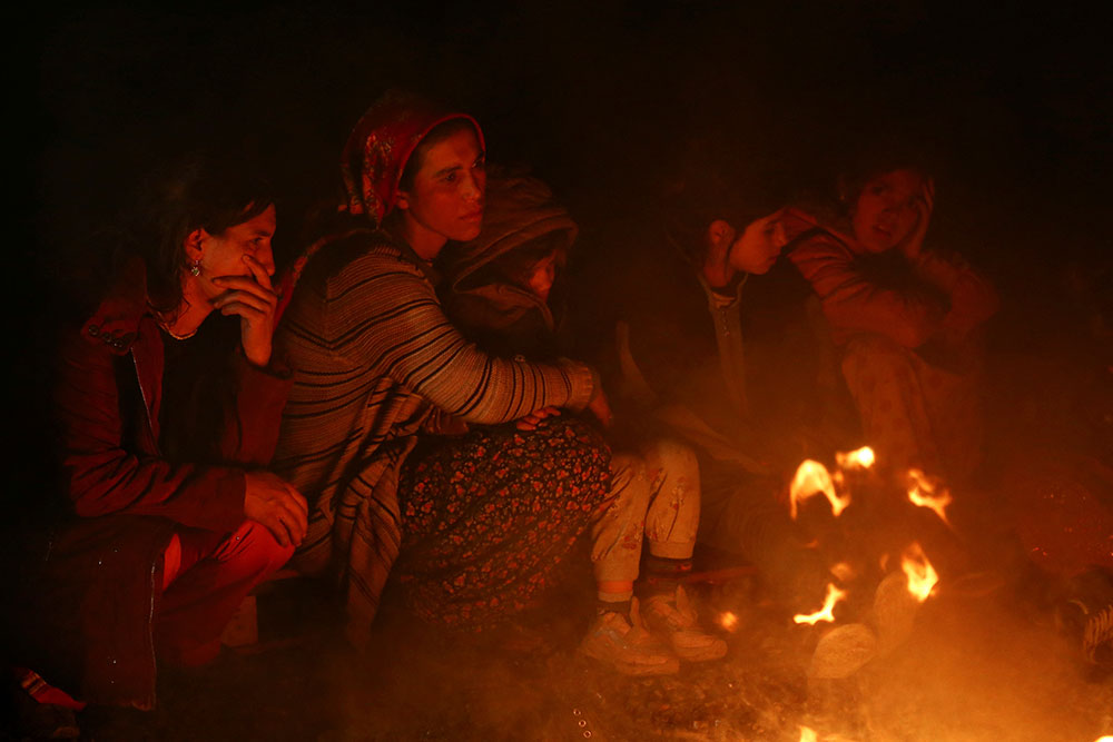 People sit around a bonfire in Kahramanmaraş, Turkey.