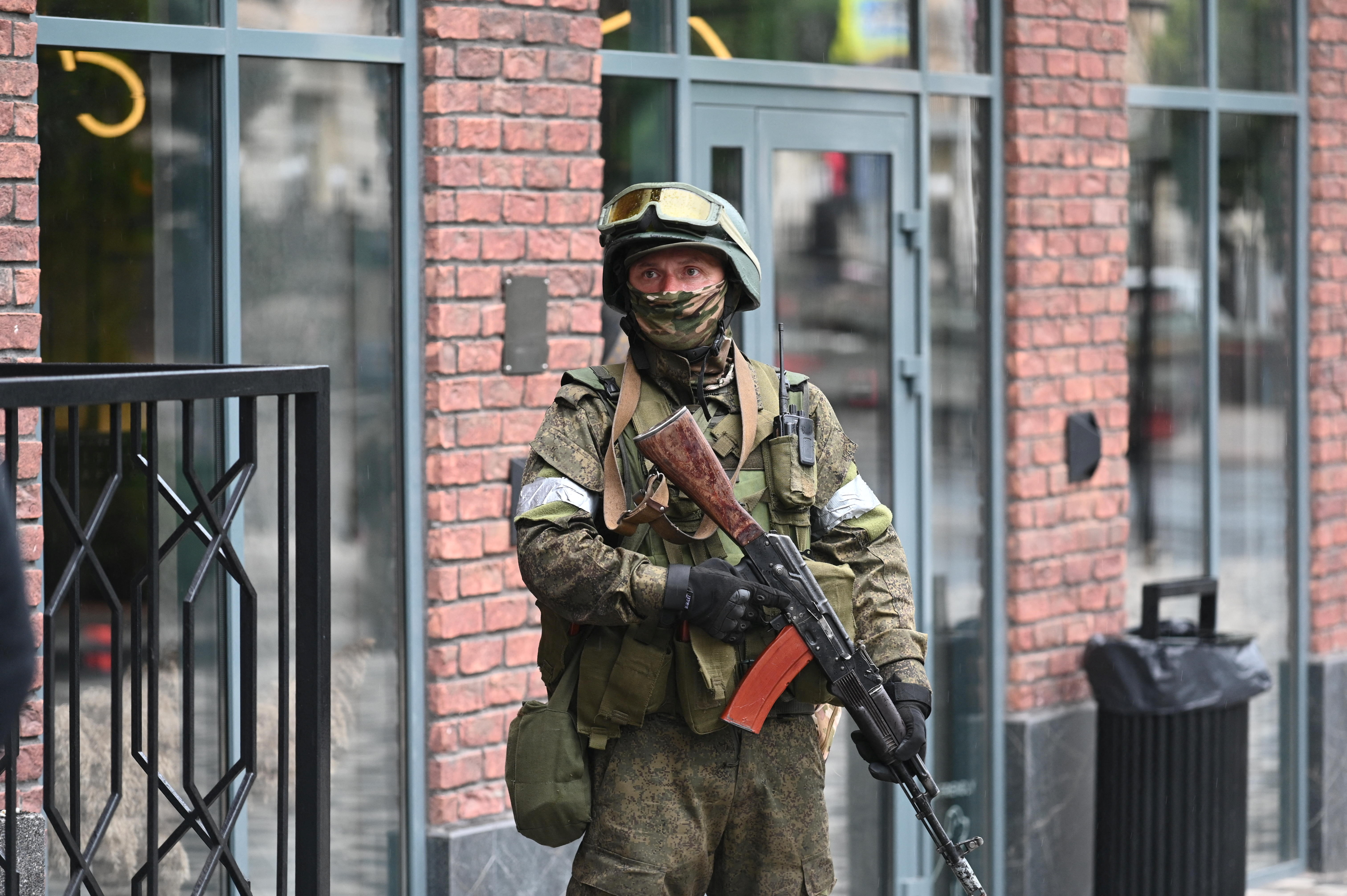 A fighter of Wagner private mercenary group stands guard in a street in Rostov, Russia, June 24, 