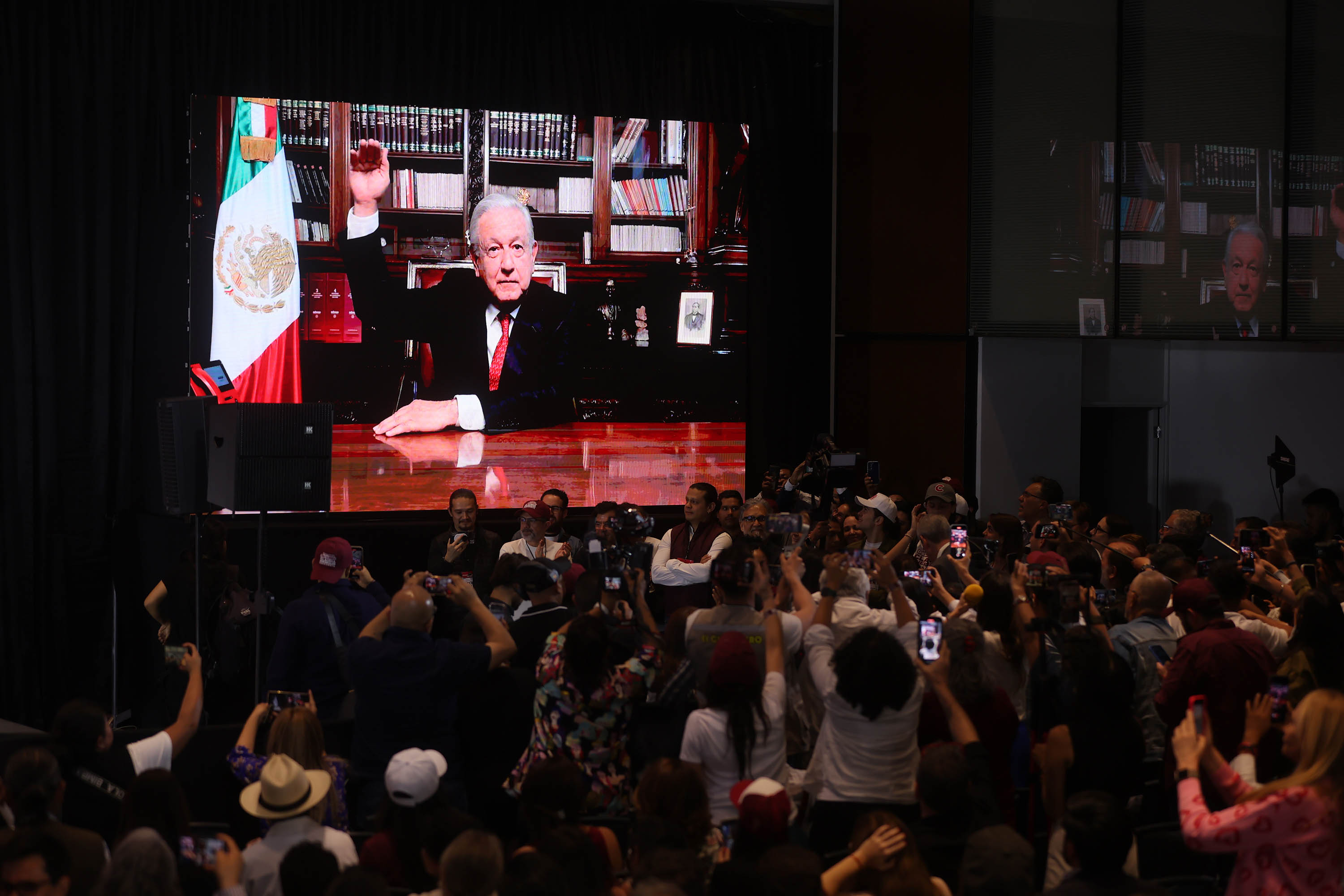 A video of outgoing Mexican President Andrés Manuel López Obrador congratulating projected president Claudia Sheinbaum is displayed at a hotel in Mexico City on June 3. 