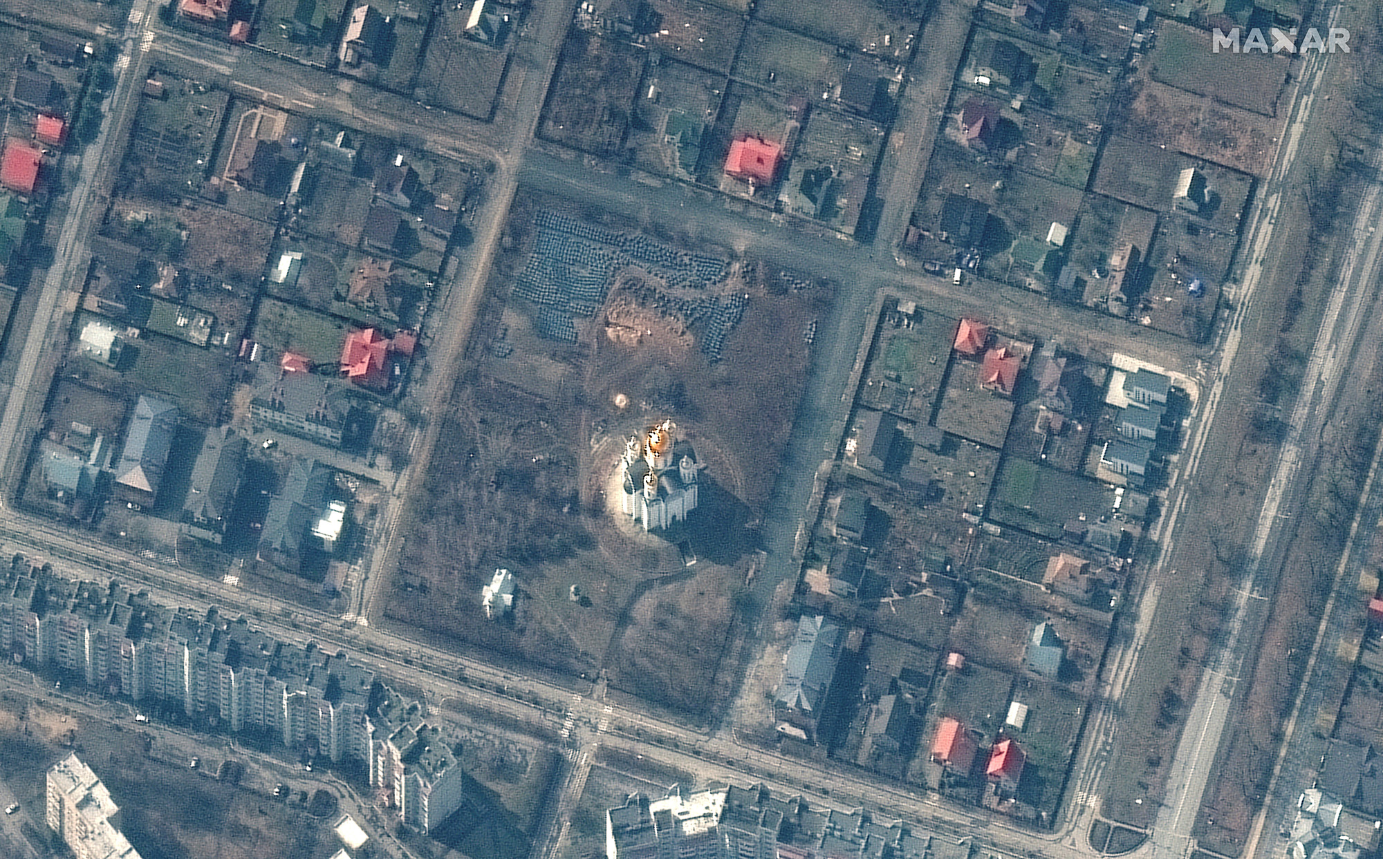 A satellite image shows a grave site with an approximately 45-foot long trench in the southwestern section of the area near the Church of St. Andrew and Pyervozvannoho All Saints, in Bucha, Ukraine, on March 31.