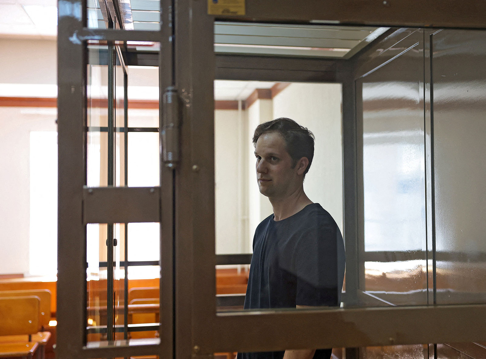 Gershkovich stands behind a glass wall of an enclosure for defendants before a court hearing to consider an appeal against his detention, in Moscow, Russia, on June 22.