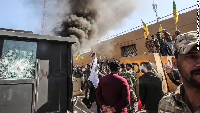Protesters set a sentry box ablaze in front of the US embassy building in the Iraqi capital, Baghdad.