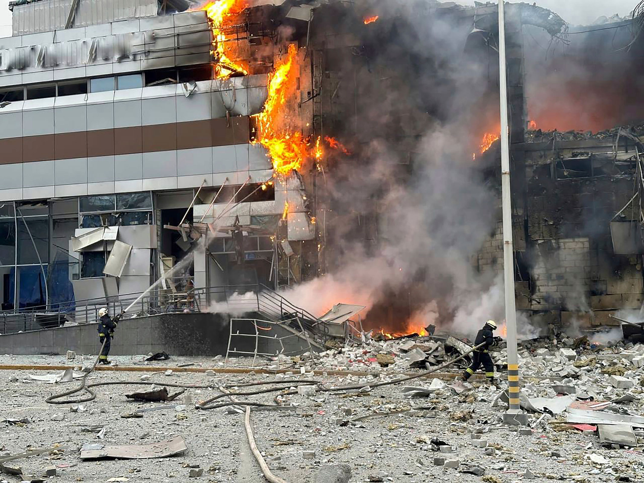 In this photo provided by the Ukrainian Emergency Service, firefighters work on the site of a building damaged after a Russian attack in Kyiv, on Friday.
