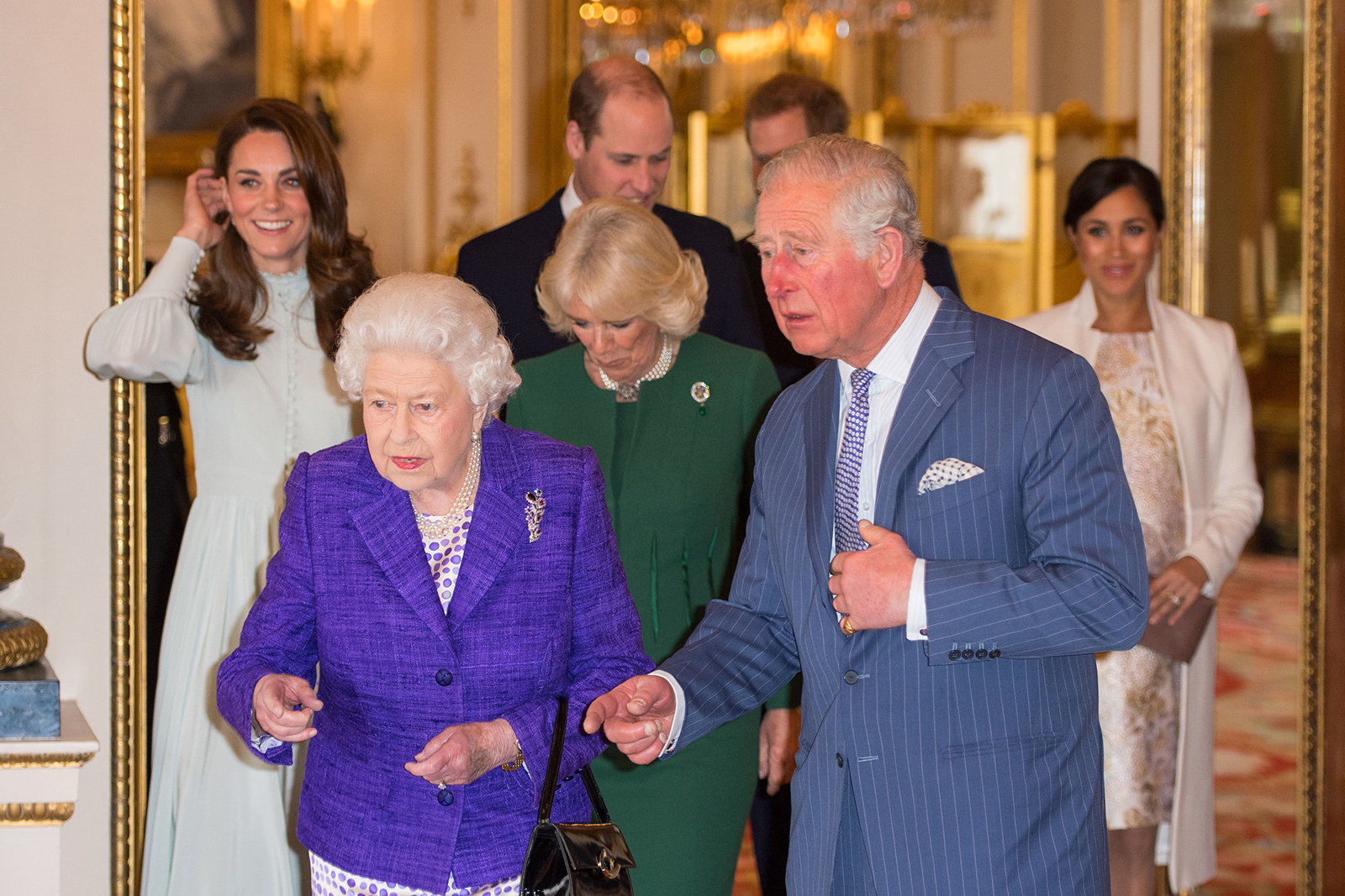 Britain's Catherine, Duchess of Cambridge, Britain's Queen Elizabeth II, Britain's Prince William, Duke of Cambridge, Britain's Camilla, Duchess of Cornwall, Britain's Prince Charles, Prince of Wales, Britain's Prince Harry, Duke of Sussex, and Britain's Meghan, Duchess of Sussex attend a reception to mark the 50th Anniversary of the investiture of The Prince of Wales at Buckingham Palace in London on March 5, 2019.