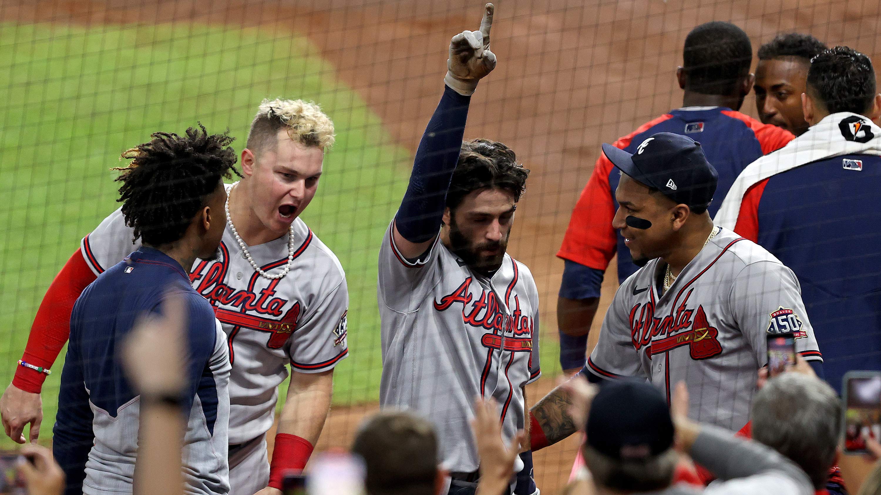 Dansby Swanson, center, of the Braves celebrates after hitting a two run home run during the fifth inning in Game 6.