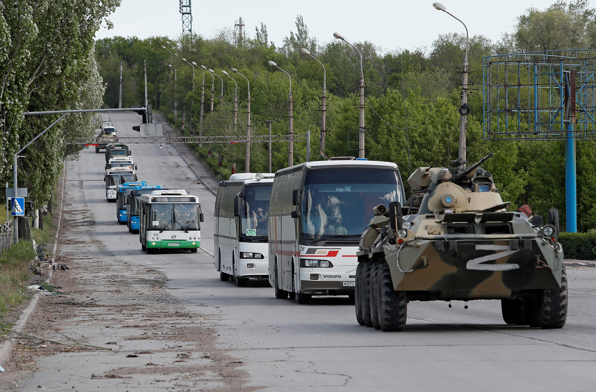 Buses carrying members of Ukrainian forces from the Azovstal steel works drive away under escort of the pro-Russian military in Mariupol, Ukraine, on May 17.
