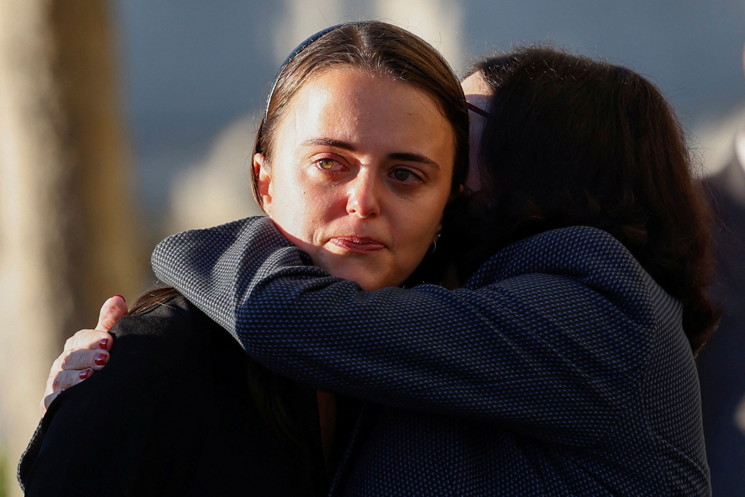 Dianne Feinstein’s granddaughter Eileen Mariano is hugged by her mother Katherine Feinstein as the body of the late senator arrives outside of City Hall.