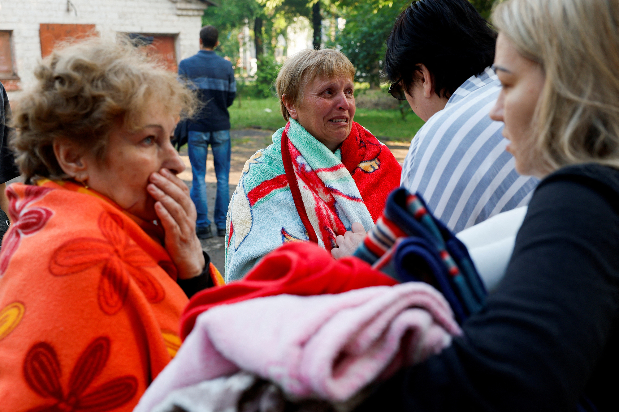 People react at a site of a residential building heavily damaged by a Russian missile strike in Kryvyi Rih, Dnipropetrovsk region, Ukraine, on June 13.