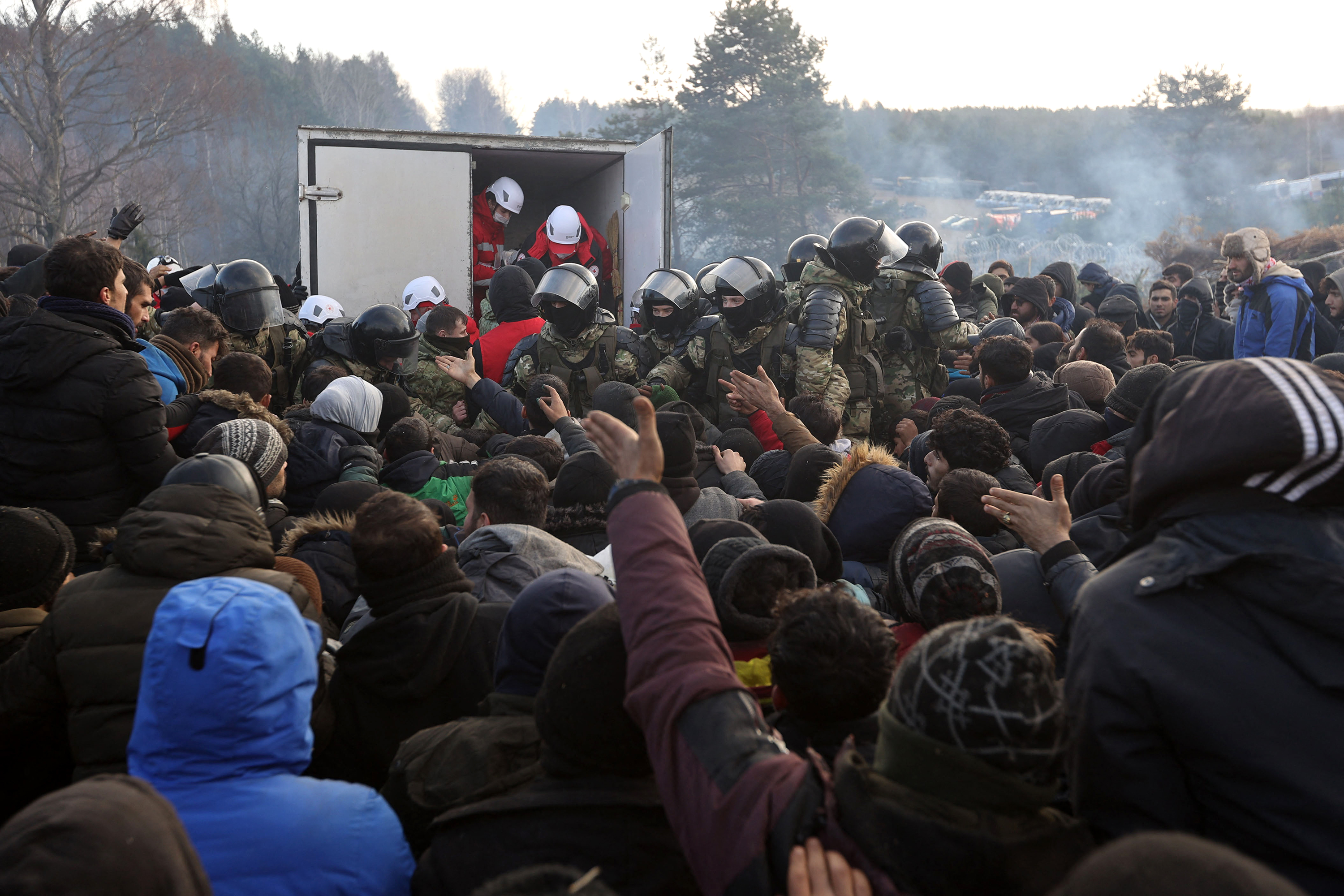 Migrants gather to receive humanitarian aid in a camp on the Belarus-Poland border on November 12. 