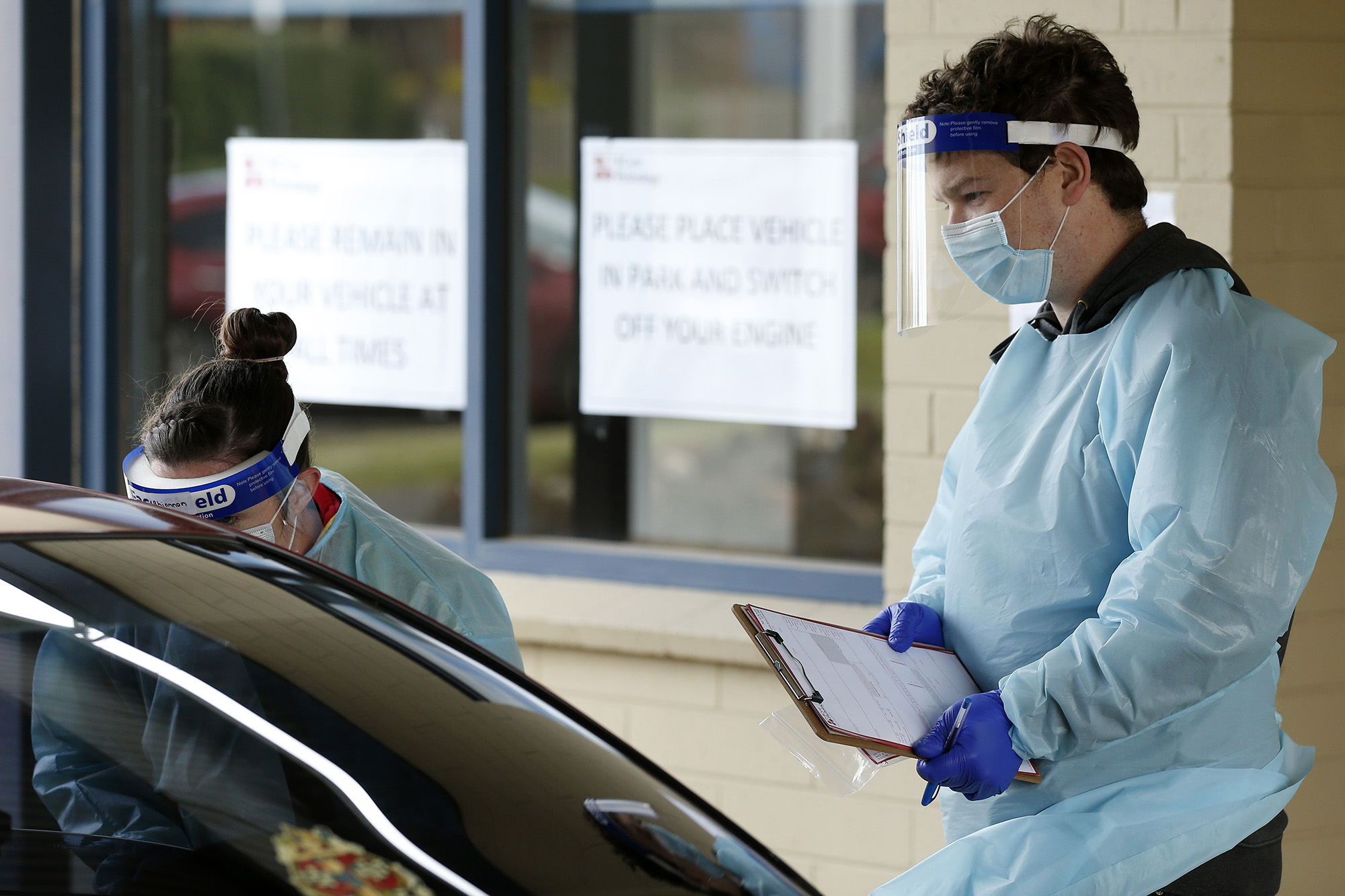 Medical professionals perform coronavirus testing at a drive-through clinic on August 21, in Ballarat in Victoria, Australia. 