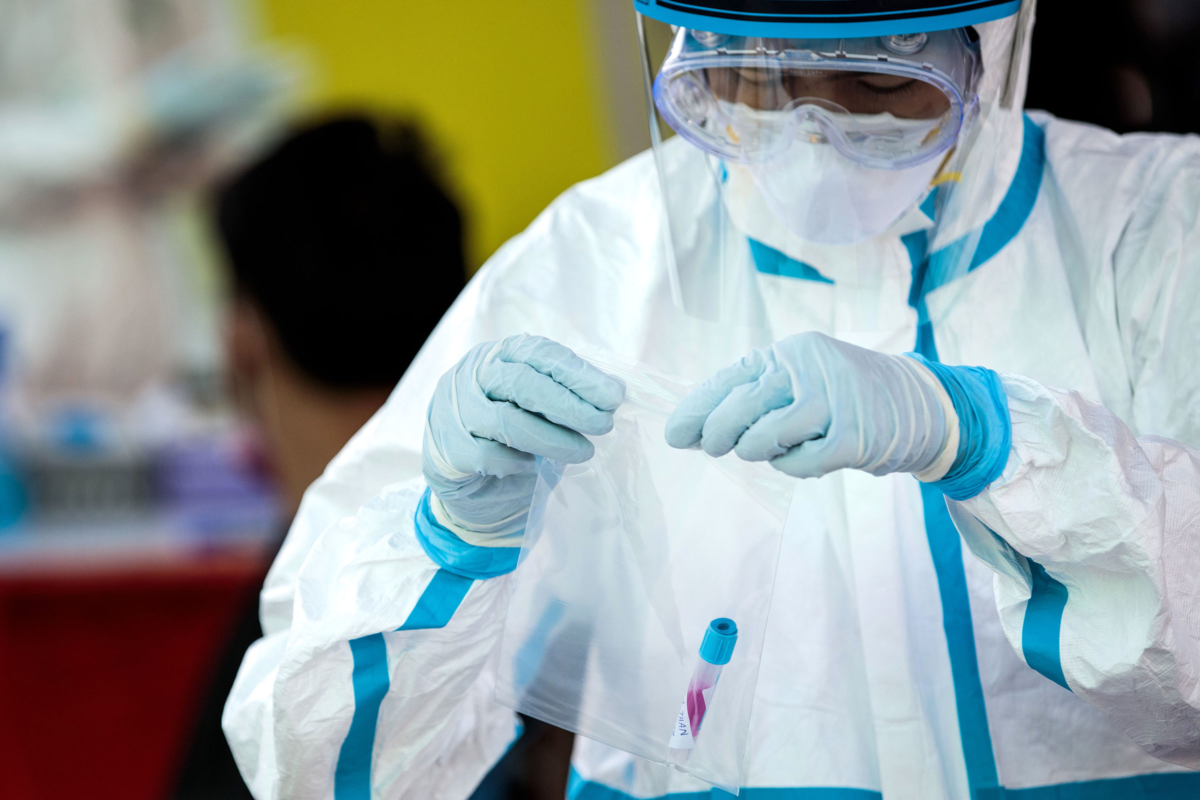 A medical official bags a swab sample to test for Covid-19 on December 19, 2020 in Samut Sakhon, Thailand.