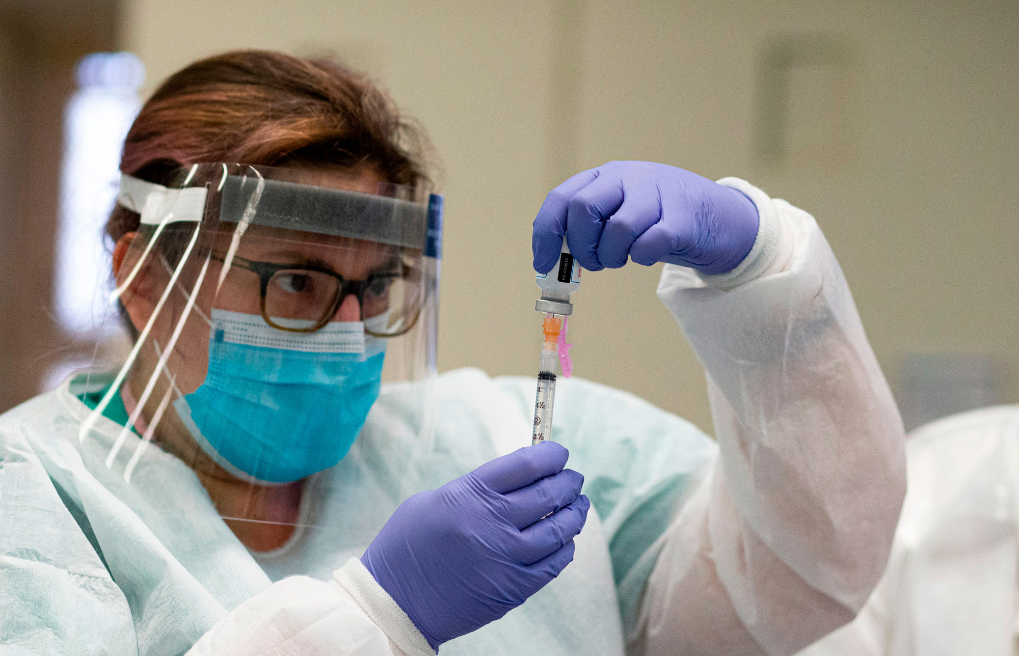 A nurse prepares a dose of the Moderna coronavirus disease vaccine at South Bronx Educational Campus in New York on January 10.