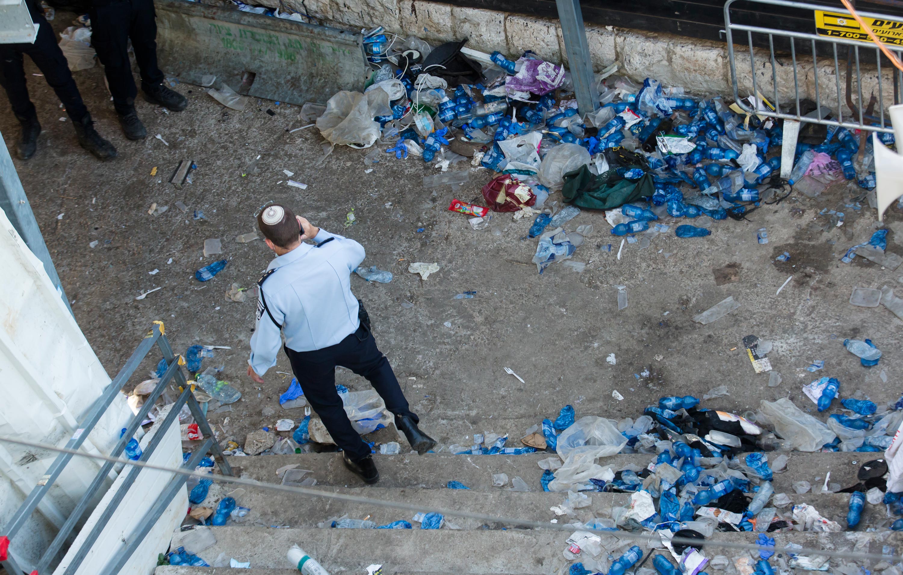 A police officer walks at the scene in Mount Meron on April 30 in Meron, Israel. 