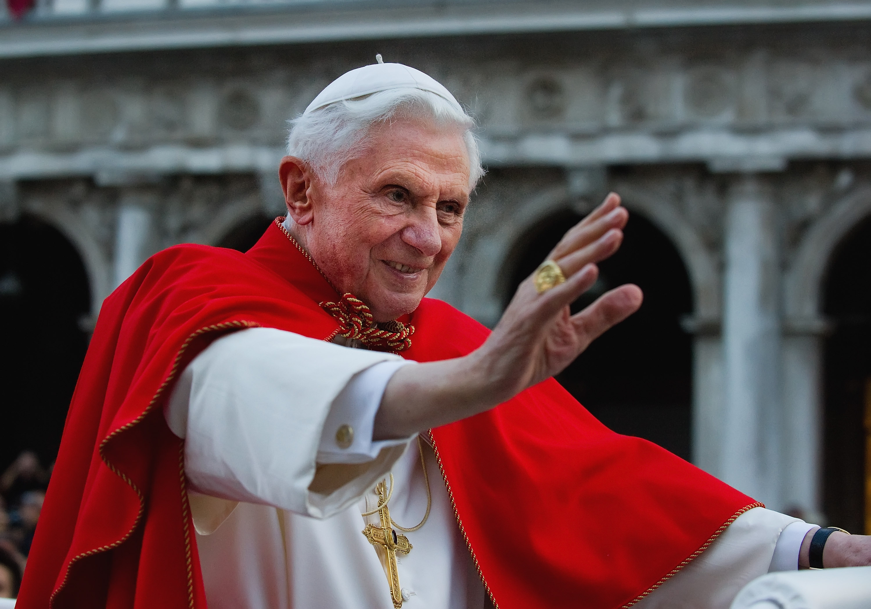 Pope Benedict XVI greets the crowd gathered in St. Mark's Square while crossing it on an electric car on May 7, 2011, in Venice, Italy.