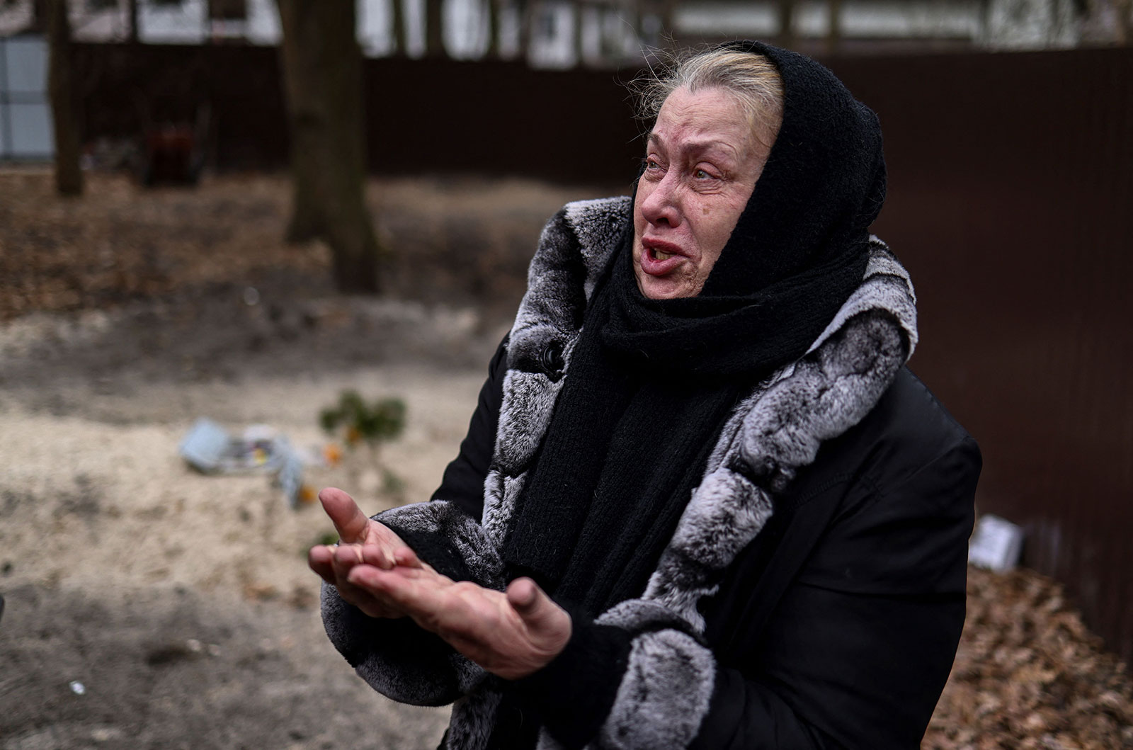 Resident Tetiana Ustymenko weeps over the grave of her son, buried in the garden of her house in Bucha on Wednesday, April 6. 