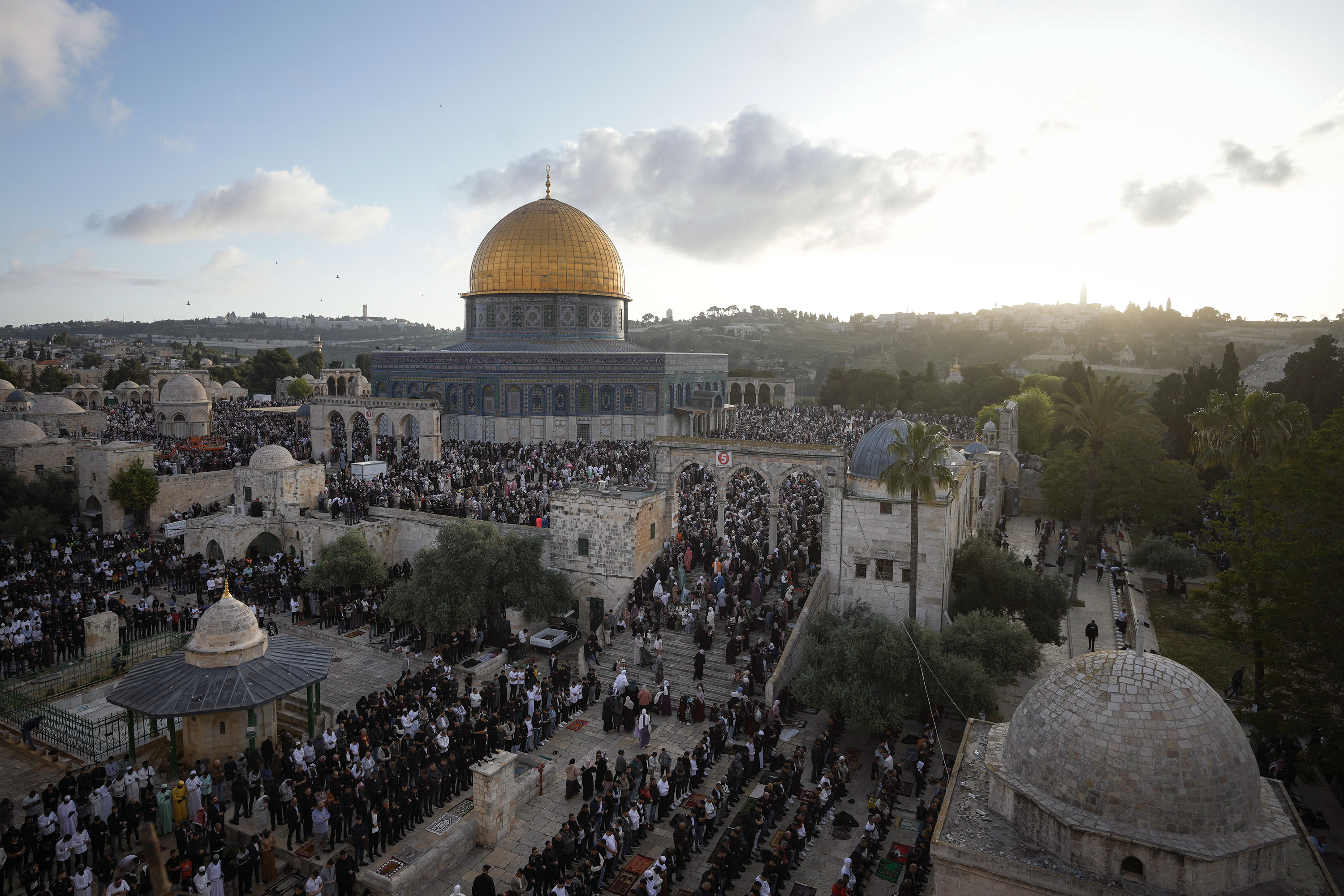 Palestinians offer Eid al-Fitr prayers by the Dome of the Rock in the al-Aqsa compound on April 21, 2023. 
