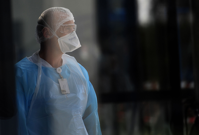 A medical worker waits for a patient's arrival outside a hospital in Lorient, western France, on Wednesday, the sixth day of the country's coronavirus lockdown.