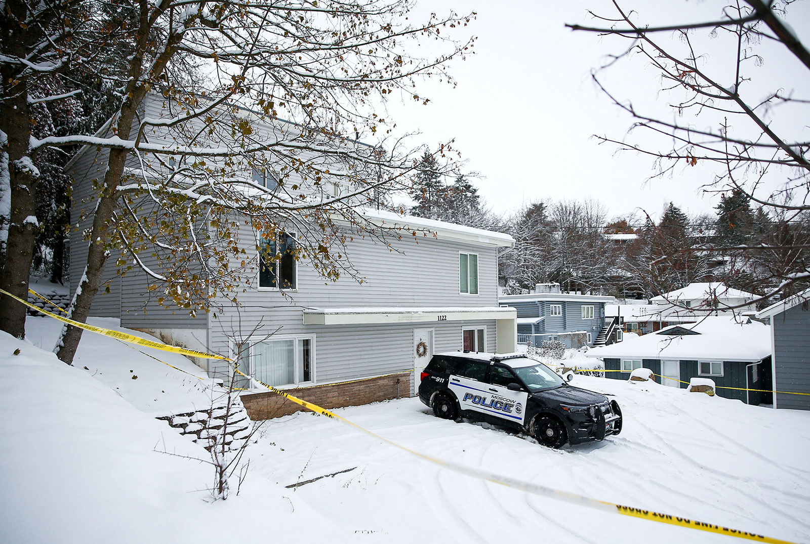 Police tape surrounds the residence where four University of Idaho students were killed as Moscow Police monitor the scene in Moscow, Idaho, on November 30, 2022. 