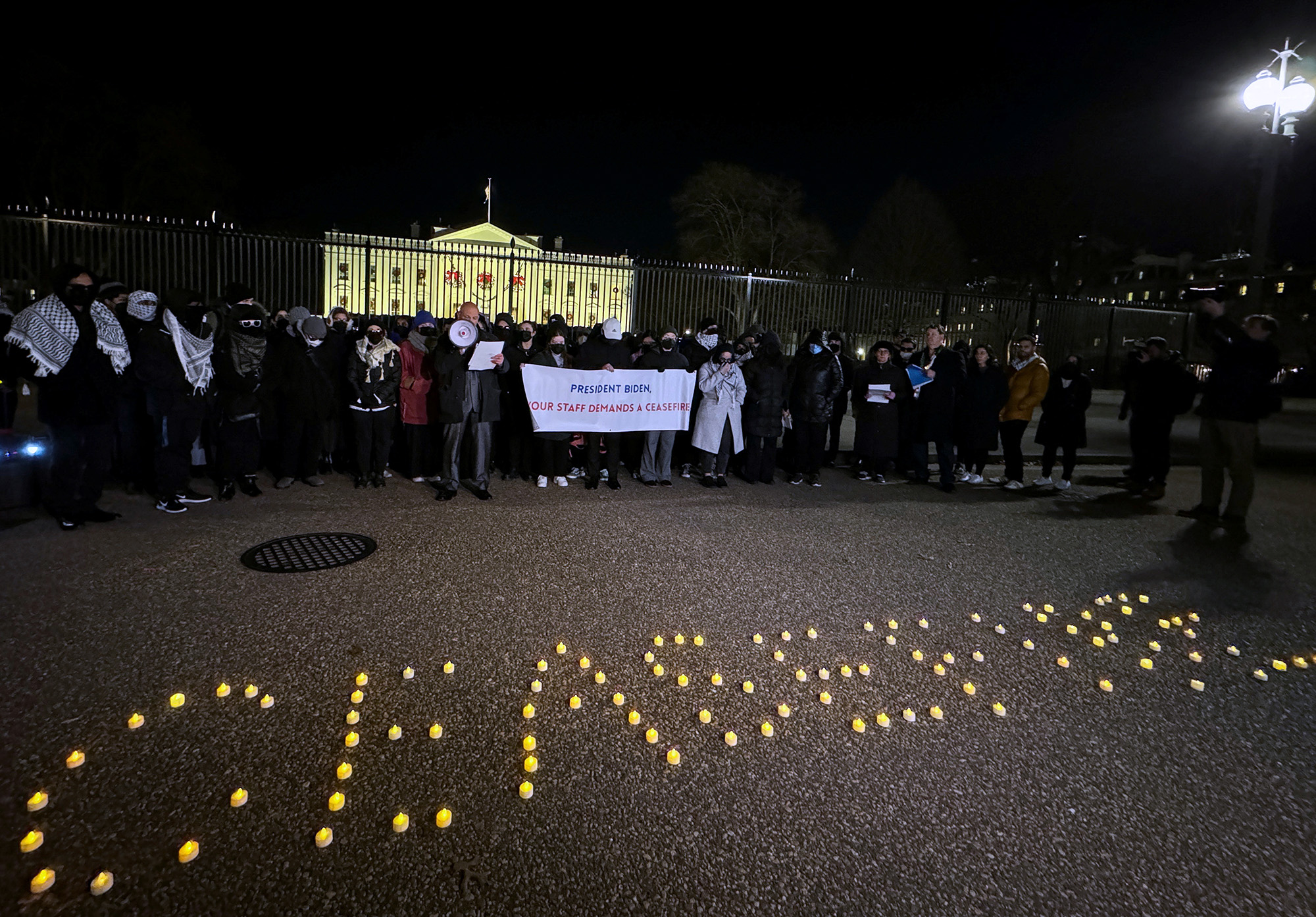 Biden administration staffers hold a vigil outside the White House to call for a permanent ceasefire in the ongoing conflict between Israel and the Palestinian Islamist group Hamas, in Washington, D.C, on December 13.