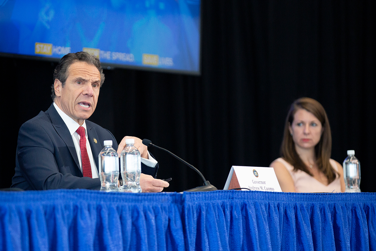 Melissa DeRosa, secretary to the governor, right, listens as New York Gov. Andrew Cuomo speaks during his daily coronavirus press briefing at SUNY Upstate Medical University on April 28, in Syracuse, New York.