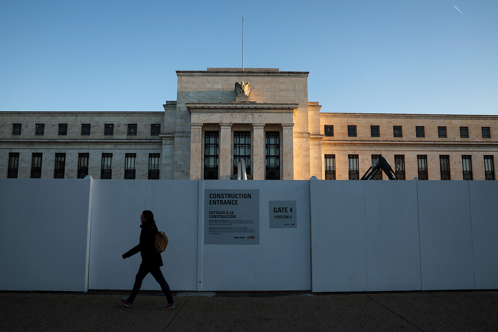 A pedestrian walks past the Federal Reserve Headquarters on March 21 in Washington, DC. 