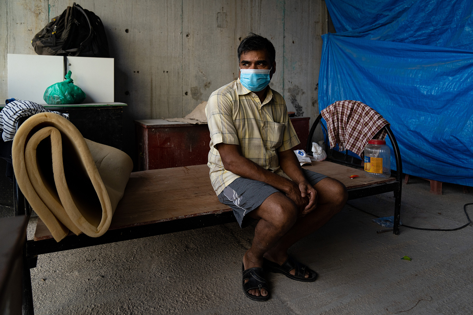 A migrant worker sits on his bed in a construction site on May 17 in Singapore.