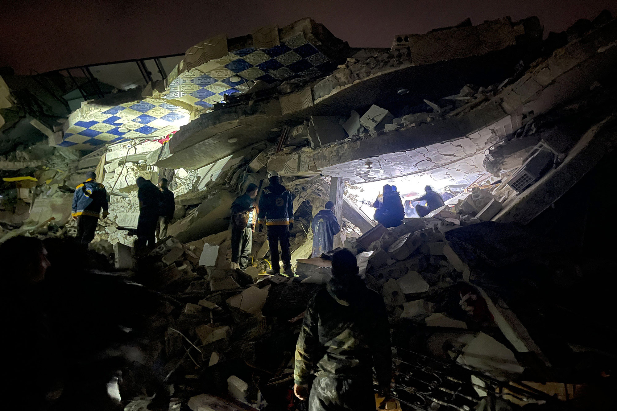 Rescue workers search the rubble of a collapsed building in Idlib, Syria, on February 6. 