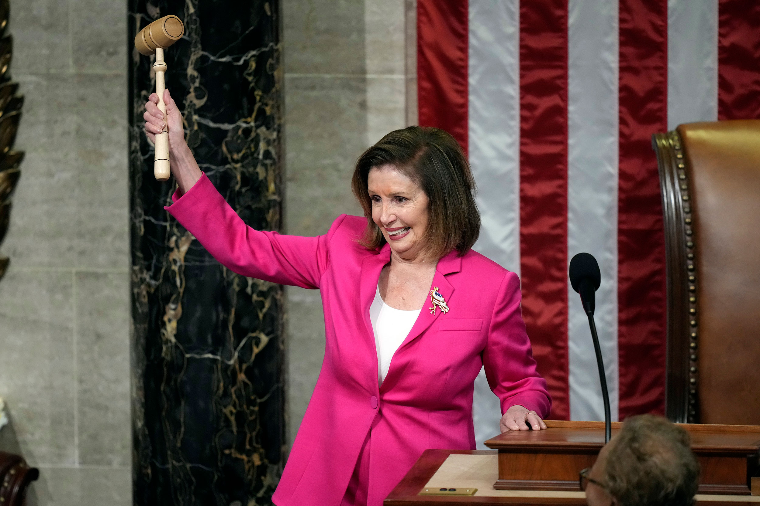 Outgoing House Speaker Nancy Pelosi holds the gavel as she calls the House to order on Tuesday.