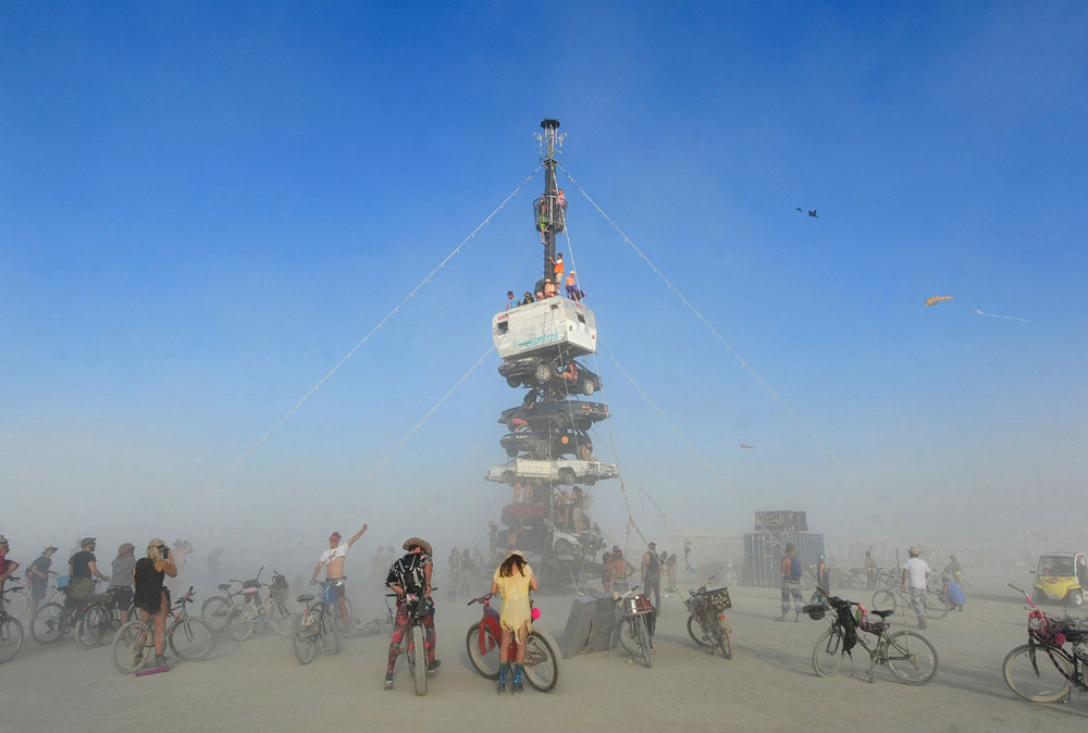 Burners climb onto an art installation at Burning Man in Gerlach, Nevada, in 2018.
