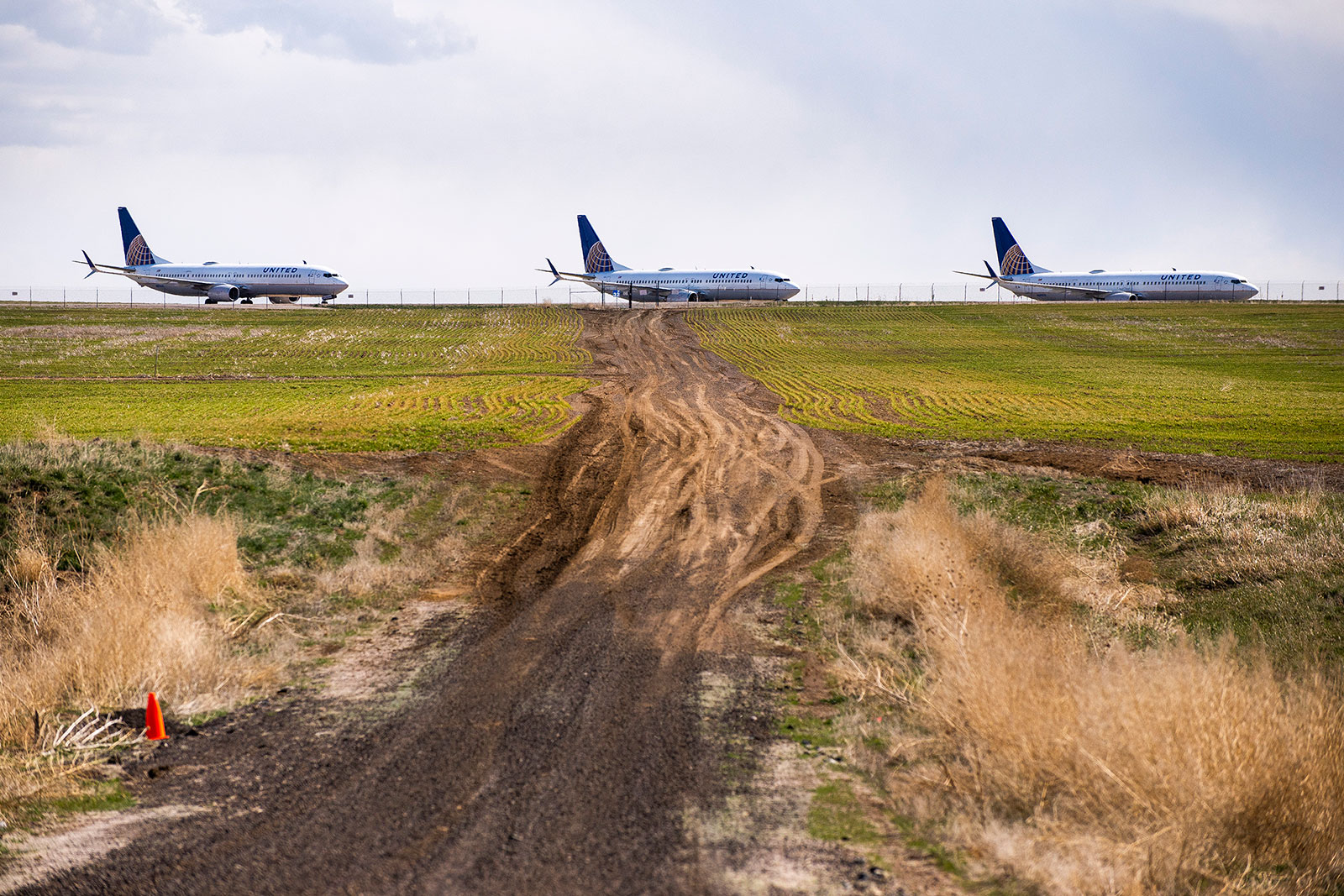 United Airlines planes sit parked on a runway at Denver International Airport.