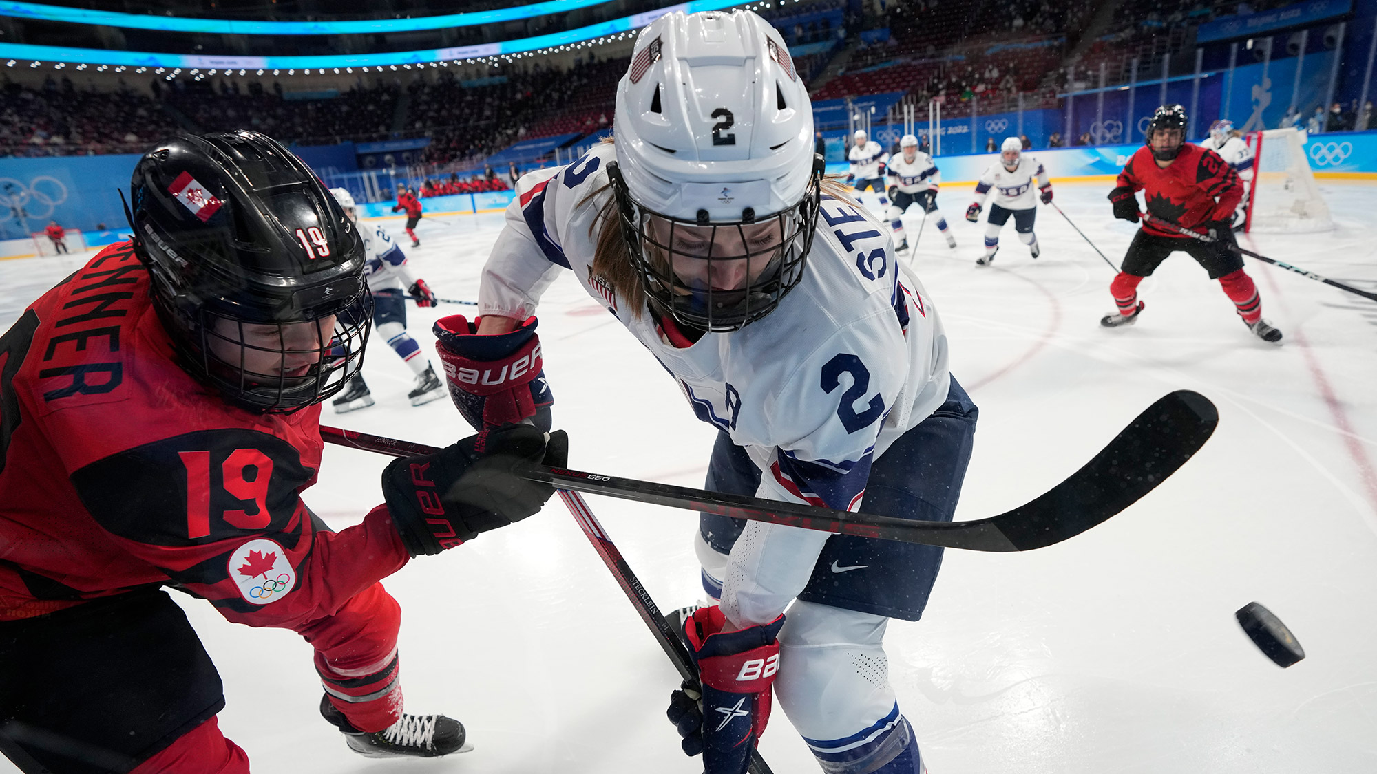 American Lee Stecklein, right, battles Canada's Brianne Jenner for the puck during the gold medal women's hockey game on Thursday.