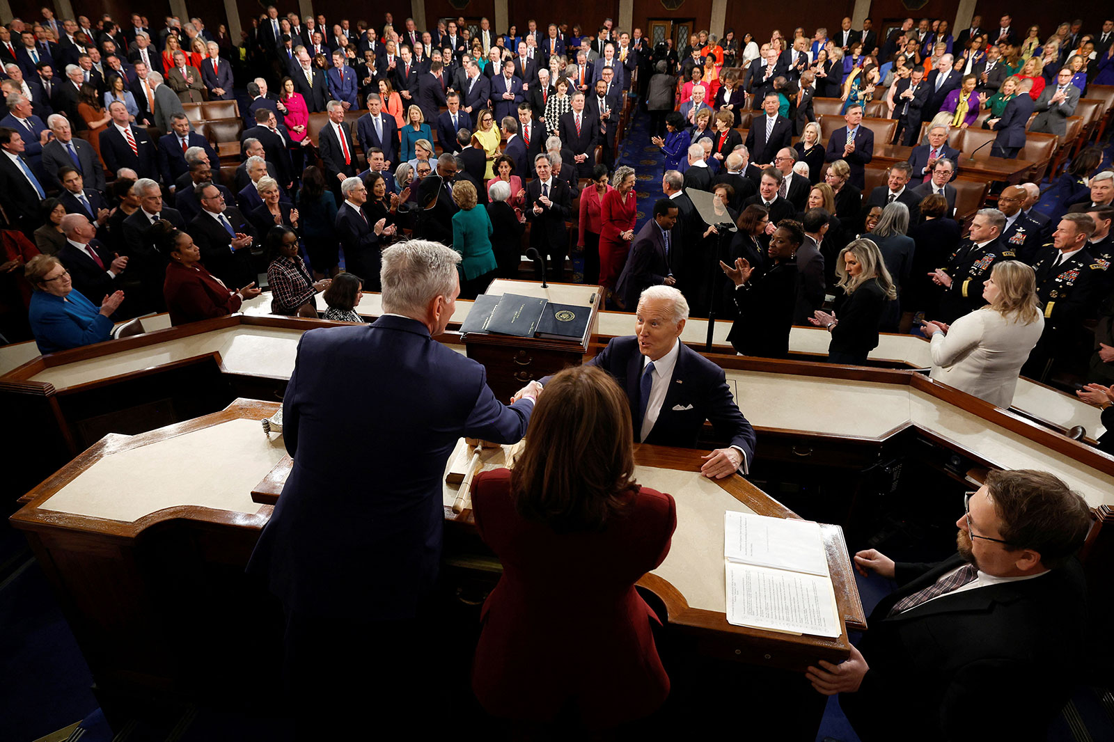 President Biden shakes hands with House Speaker Kevin McCarthy prior to his address on Tuesday.