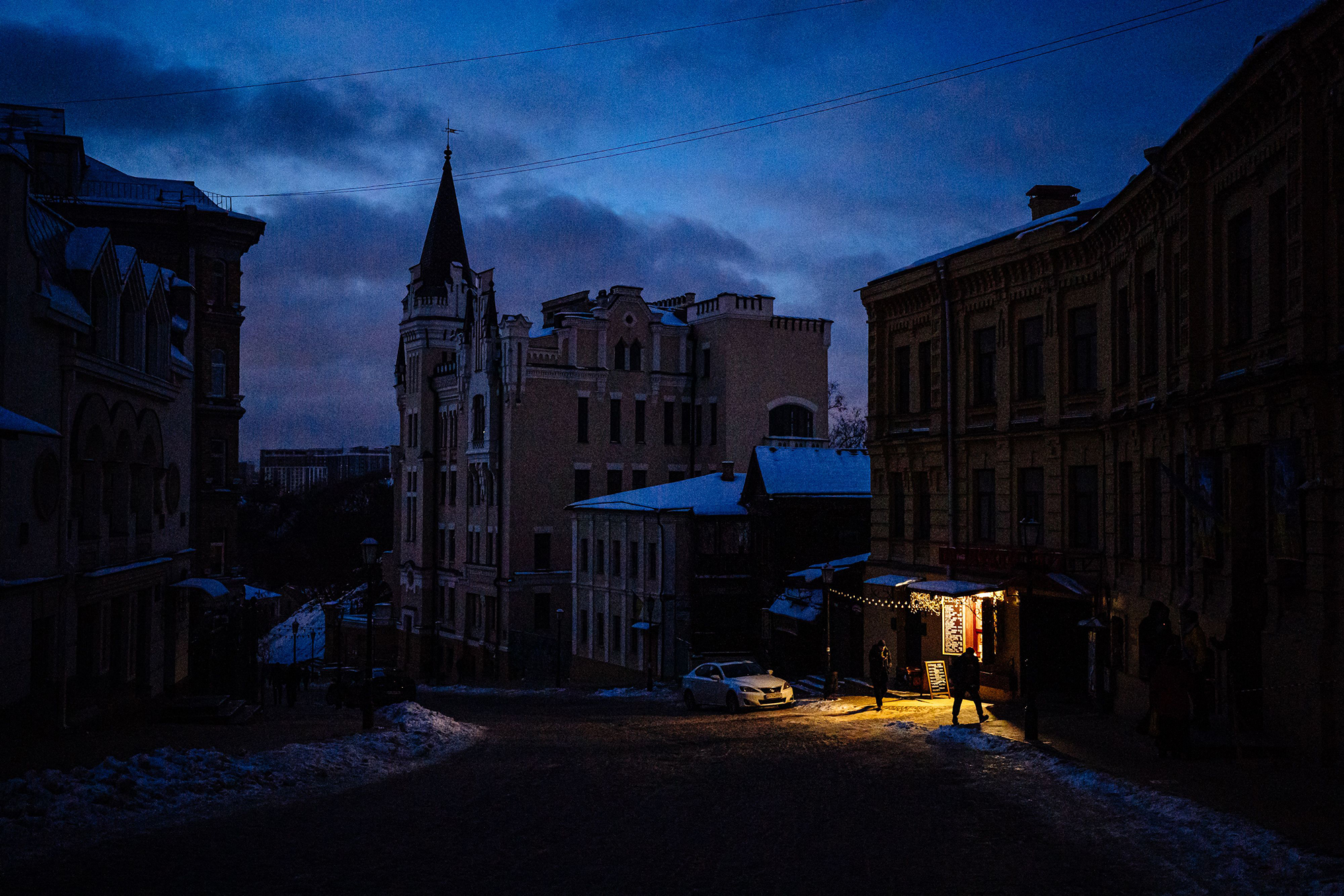 People walk down a darkened street in downtown Kyiv, Ukraine, on December 6.