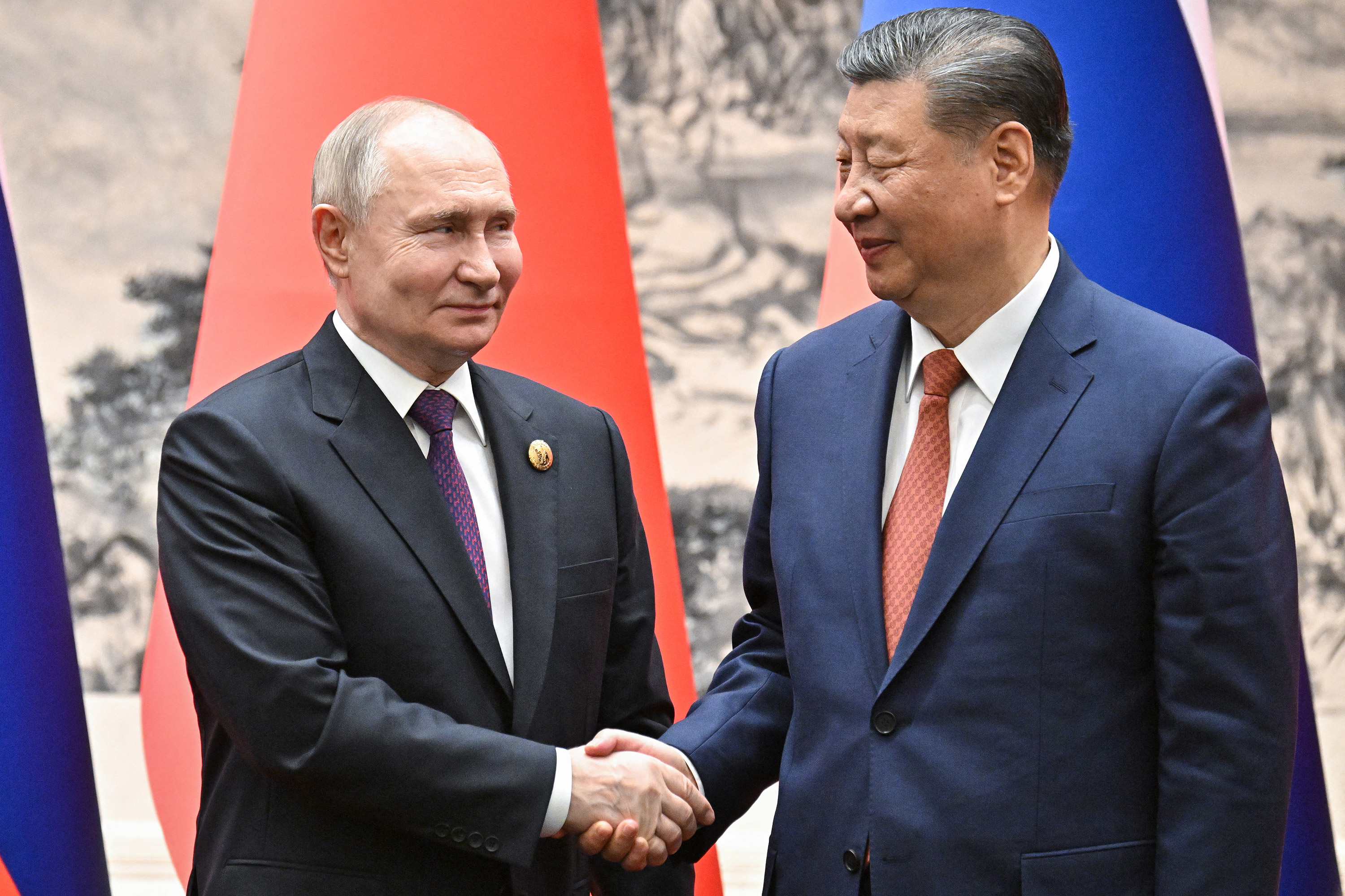 Russian President Vladimir Putin and Chinese President Xi Jinping shake hands following their talks in Beijing on Thursday.