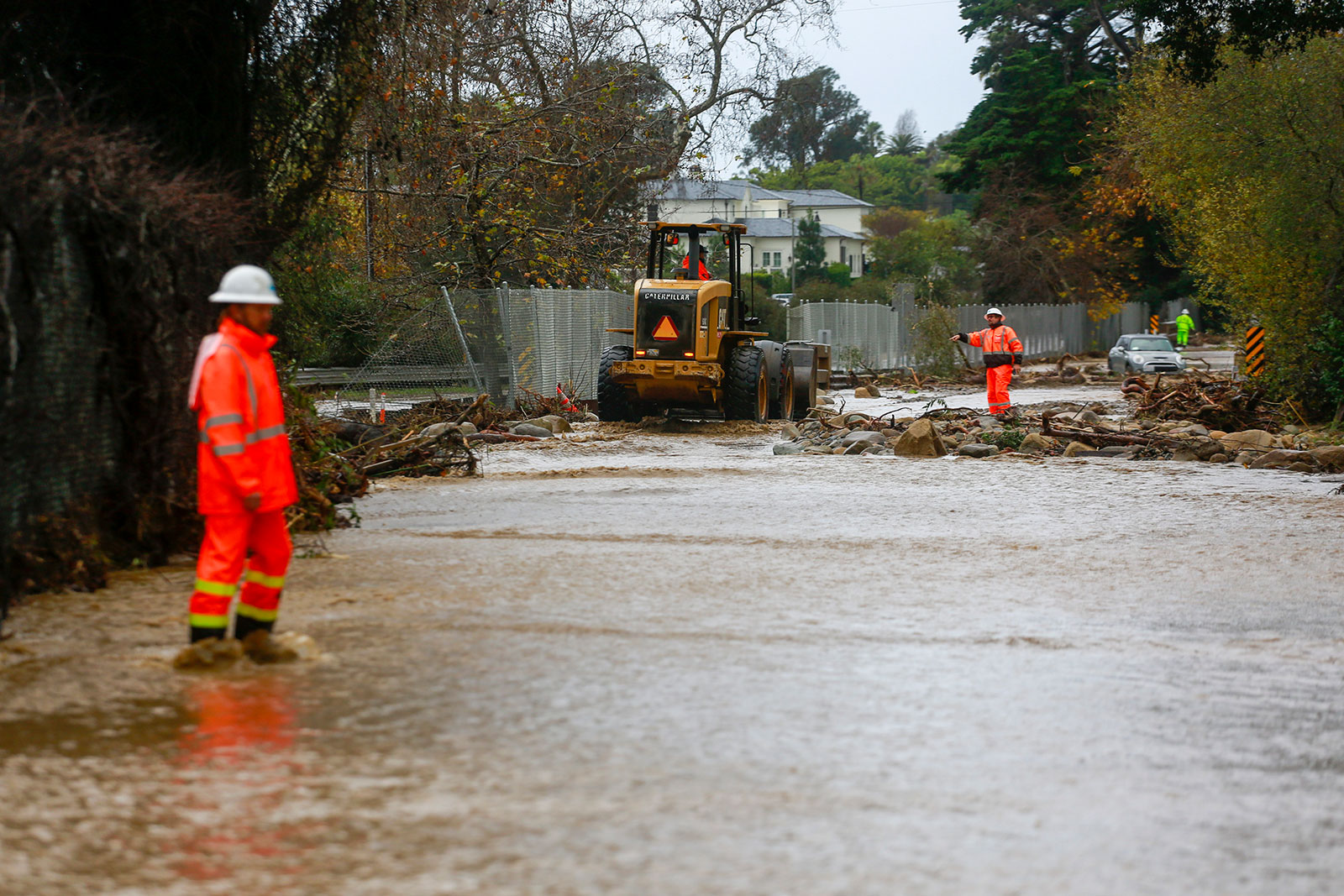 A work crew cleans up an area of Highway 101 that flooded in Montecito, California, on Tuesday, January 10.