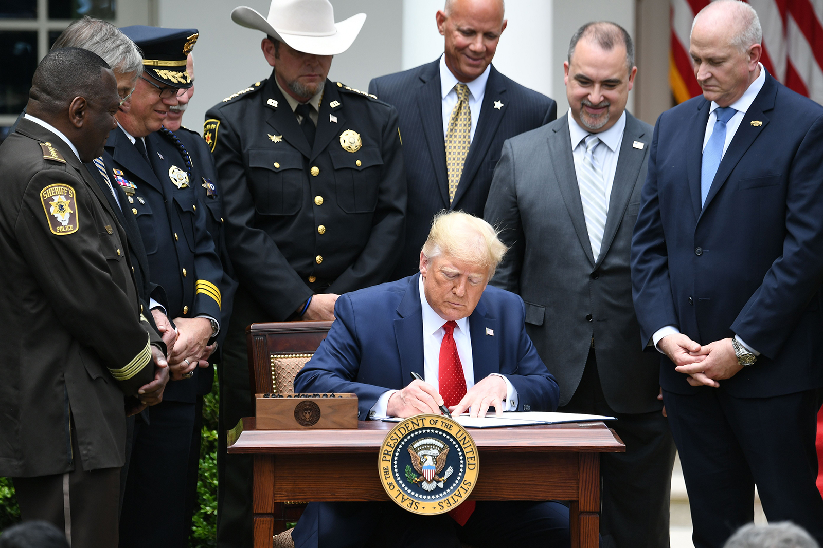 President Donald Trump signs an Executive Order on Safe Policing for Safe Communities, in the Rose Garden of the White House in Washington, on June 16.