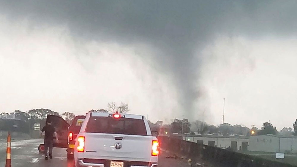 A tornado passes a highway in New Iberia, Louisiana, on Wednesday, December 14, in this still image obtained from social media video.