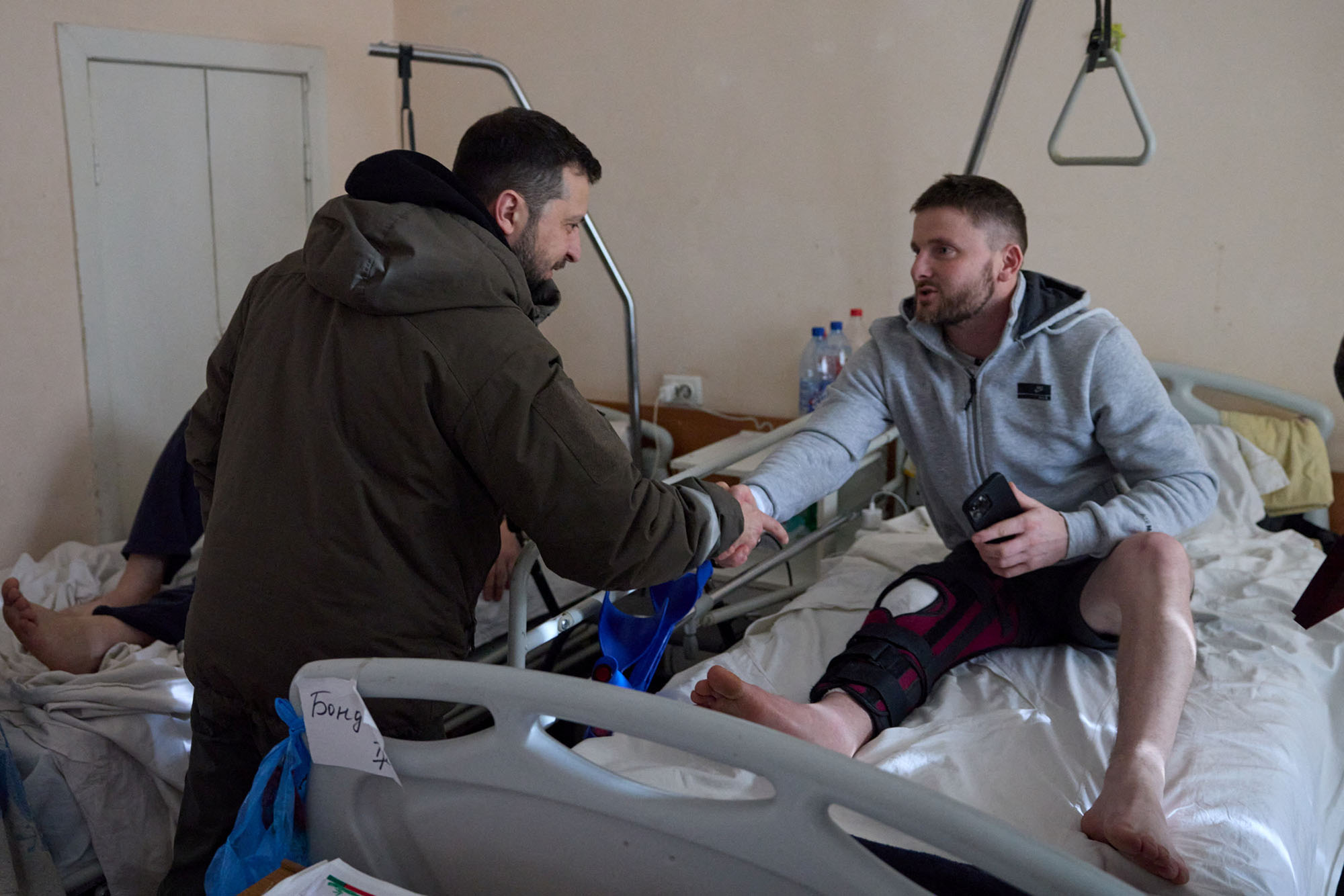 Ukraine's President Volodymyr Zelensky shakes hands with an injured service member as he visits a hospital on the Day of the Ukrainian Armed Forces, in Kharkiv, Ukraine, on December 6.