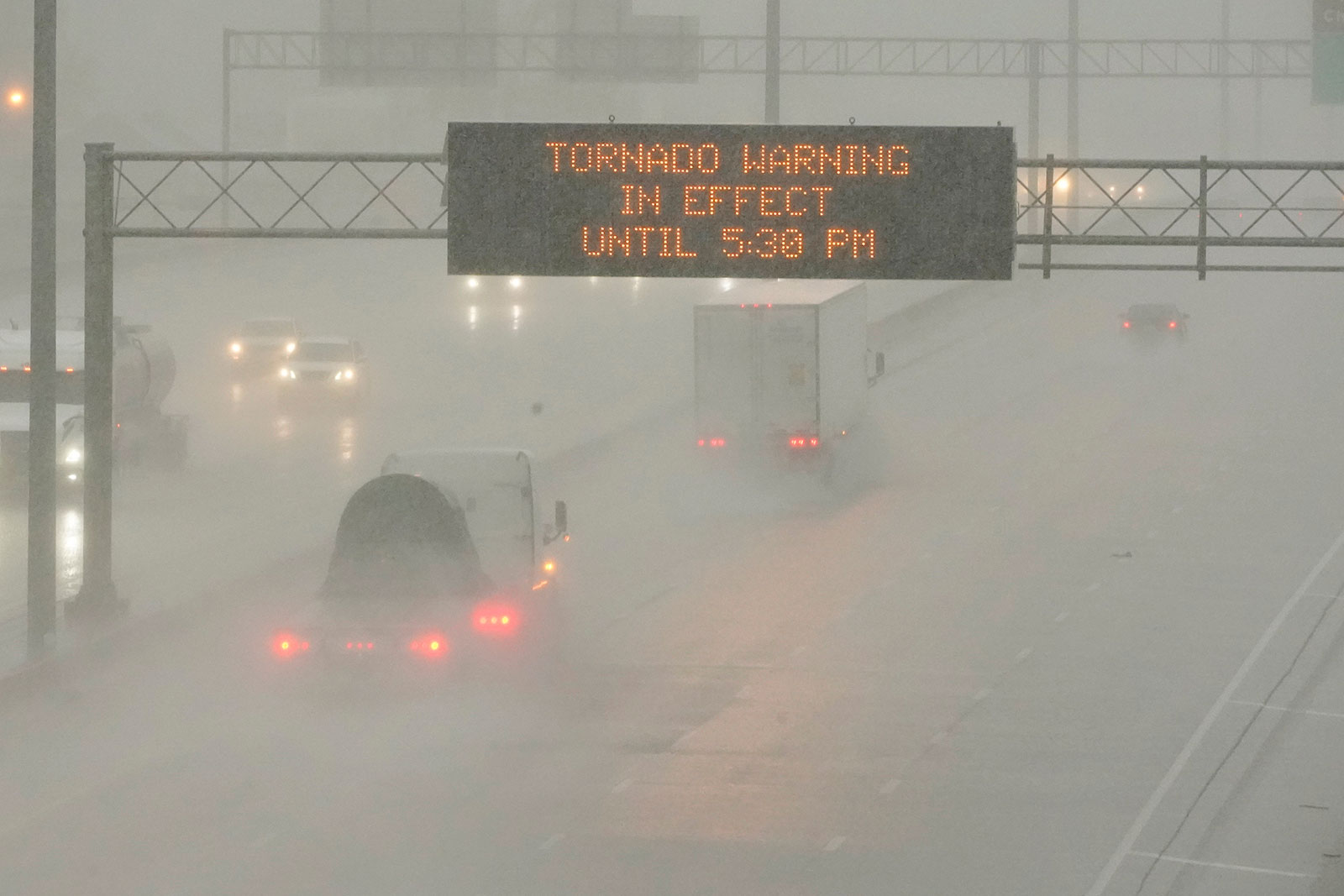 The Mississippi Department of Transportation digital message board warns drivers along I-55 southbound in Jackson of a tornado warning during a rainstorm on Wednesday.
