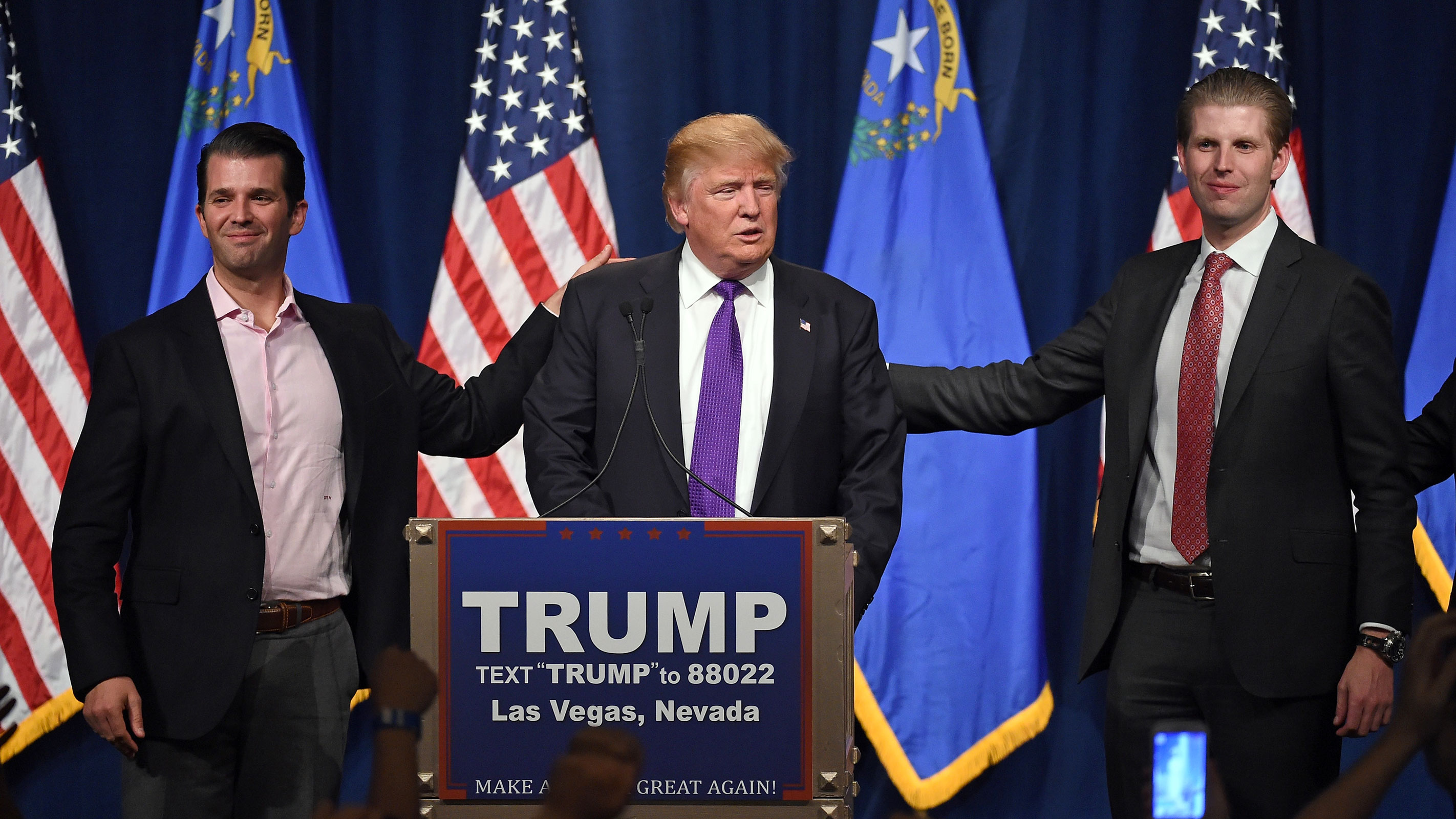Former President Donald Trump speaks as his sons Donald Trump Jr., left, and Eric Trump look on during an event in 2016 in Las Vegas.