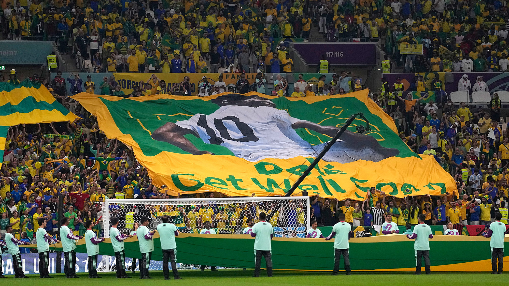 Fans hold a “get well soon” banner for Pelé during the World Cup match between Brazil and Cameroon on Friday, December 2. 