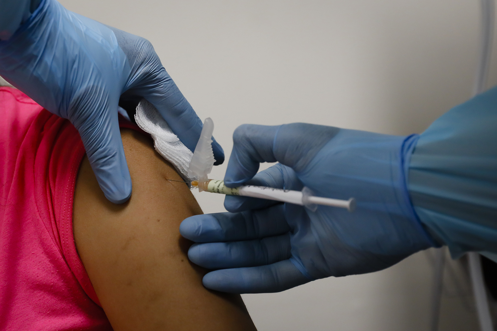 A health worker injects a woman during clinical trials for a Covid-19 vaccine at Research Centers of America in Hollywood, Florida, on September 9.