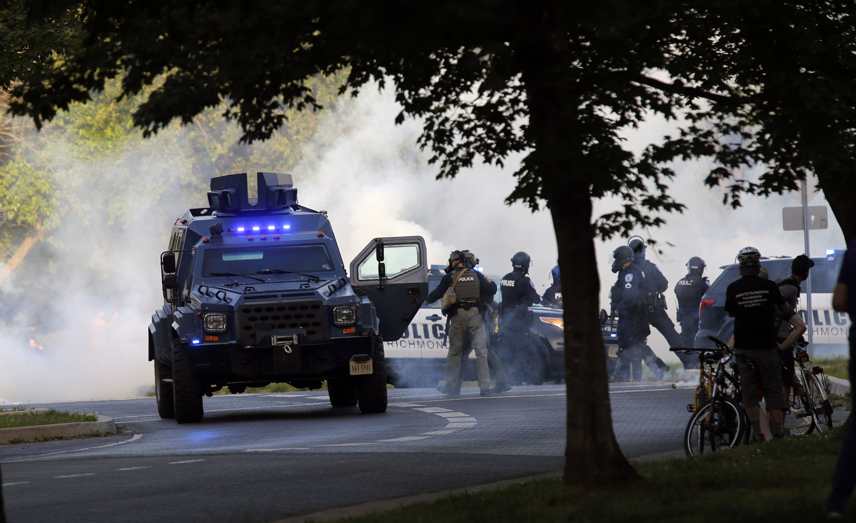 A State Police tactical vehicle is surrounded by a cloud of tear gas at the Lee Monument on Monument Avenue in Richmond, Va, on Monday, June 1. 