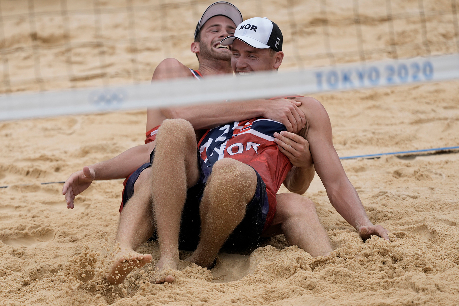 Norway's Anders Berntsen Mol, left, and teammate Christian Sørum celebrate winning a beach volleyball gold medal on Saturday.
