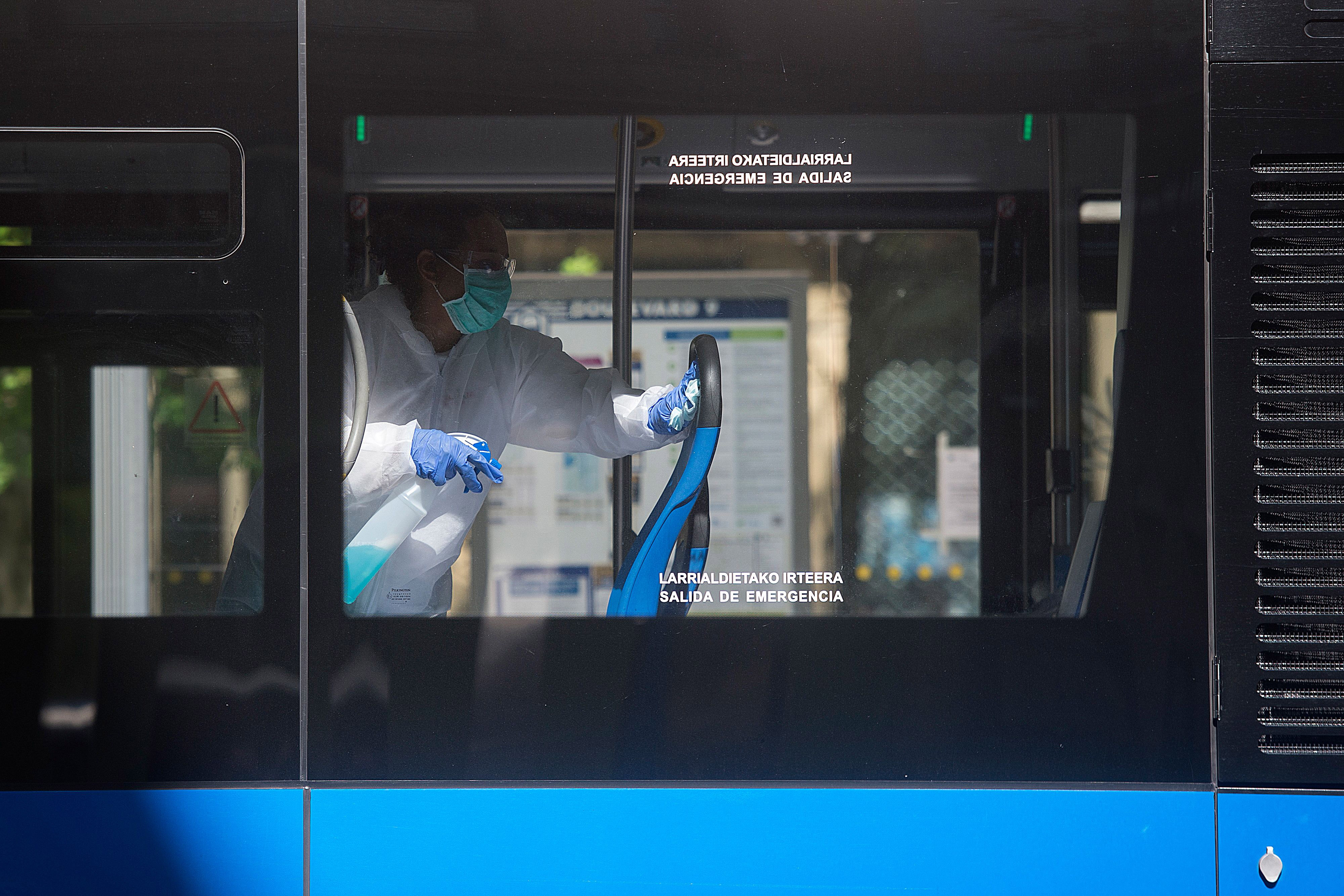 An employee cleans a public bus in the Spanish Basque city of San Sebastián on April 15.