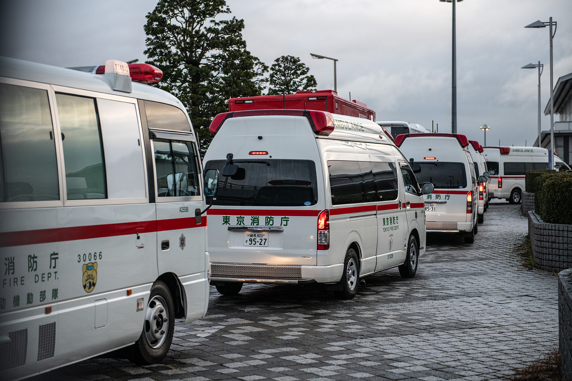 Ambulances line up ahead of the arrival of an airplane carrying Japanese citizens repatriated from Wuhan amidst the coronavirus outbreak.